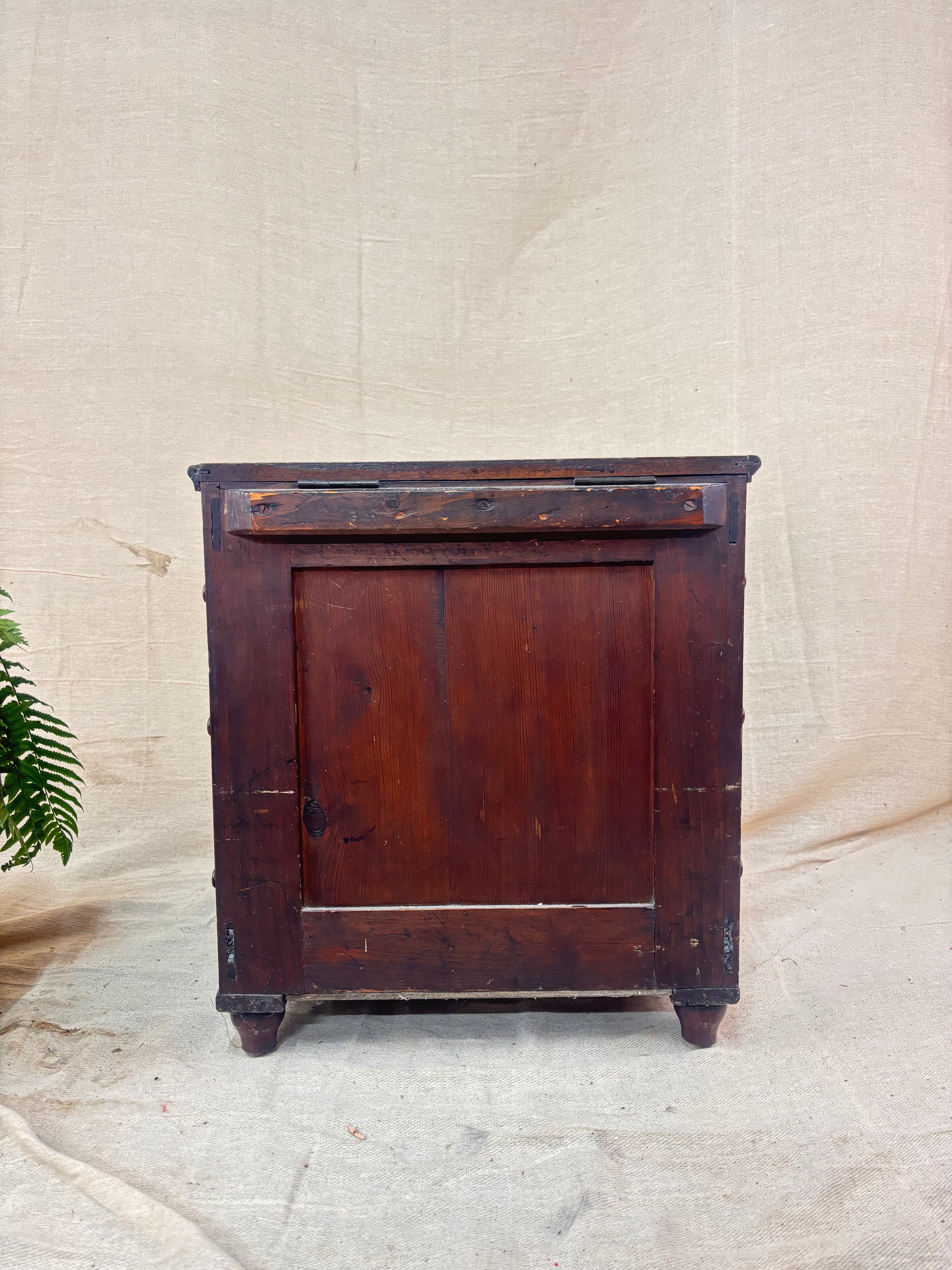 Vintage wooden cabinet on a textured beige background