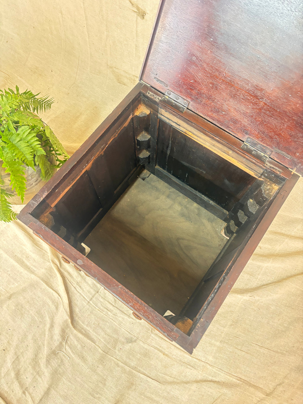 Wooden box with a lid on a beige fabric background