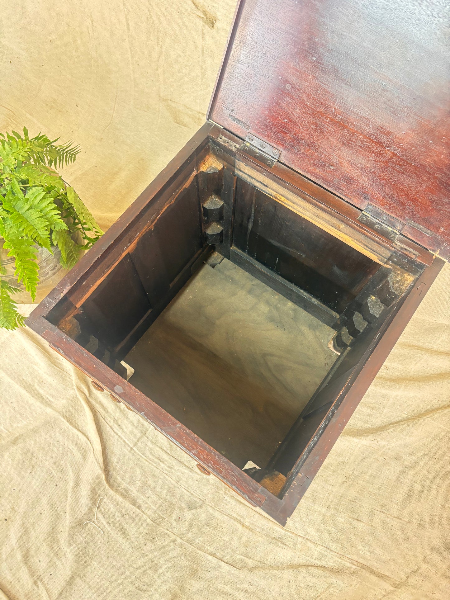 Wooden box with a lid on a beige fabric background