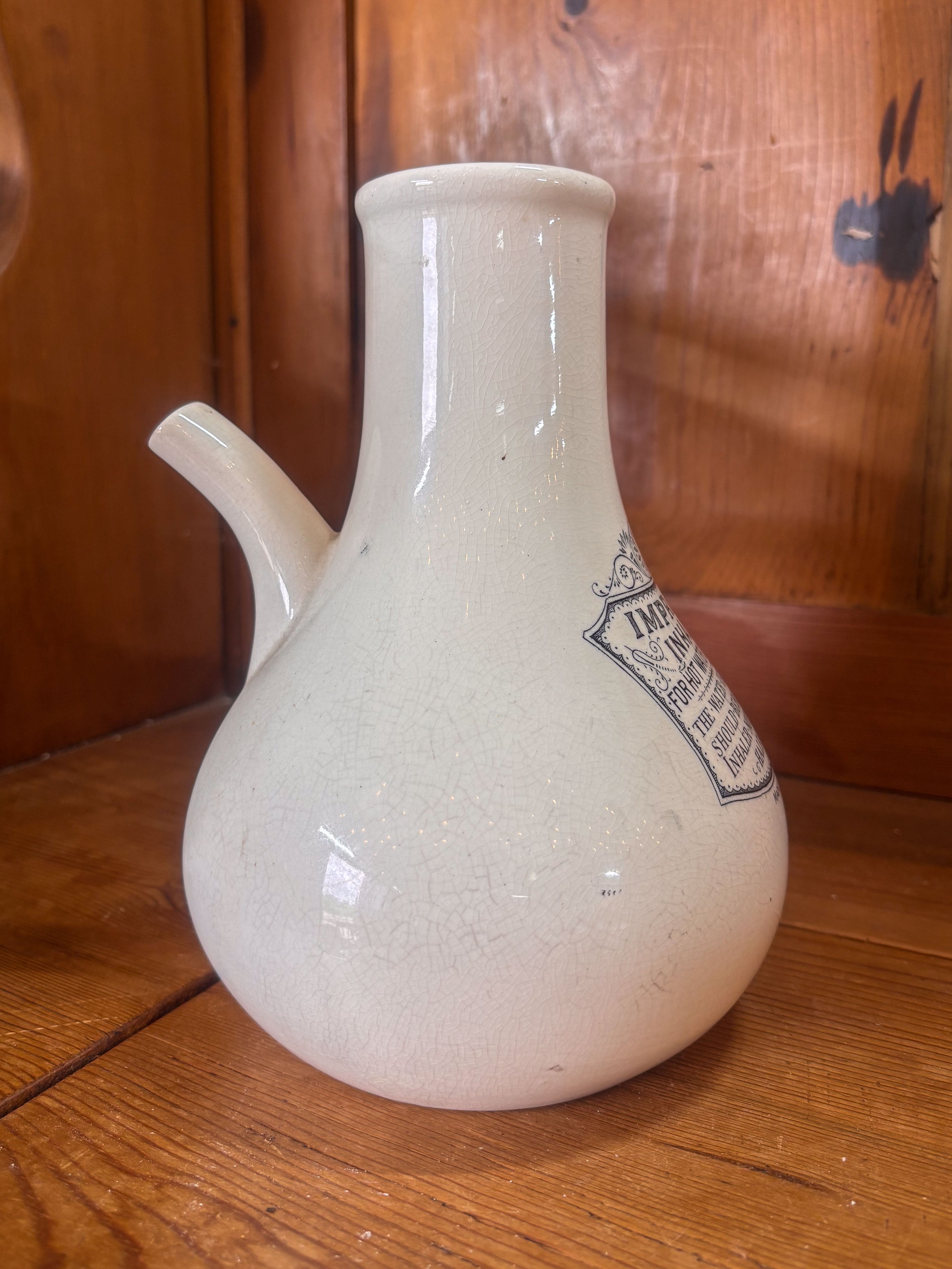 White ceramic inhaler with a label on a wooden surface