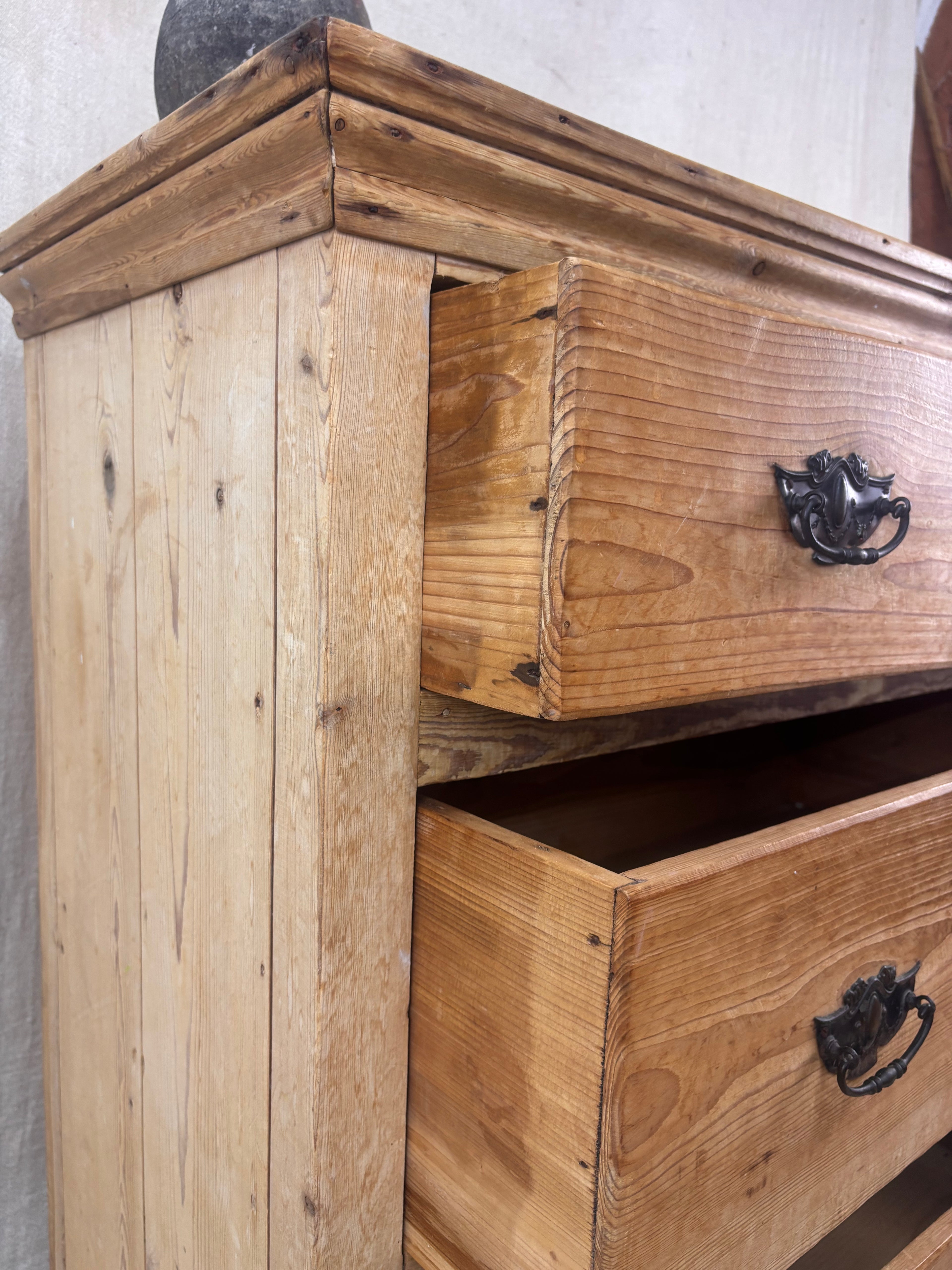 Wooden dresser with two drawers and metal handles on a neutral background