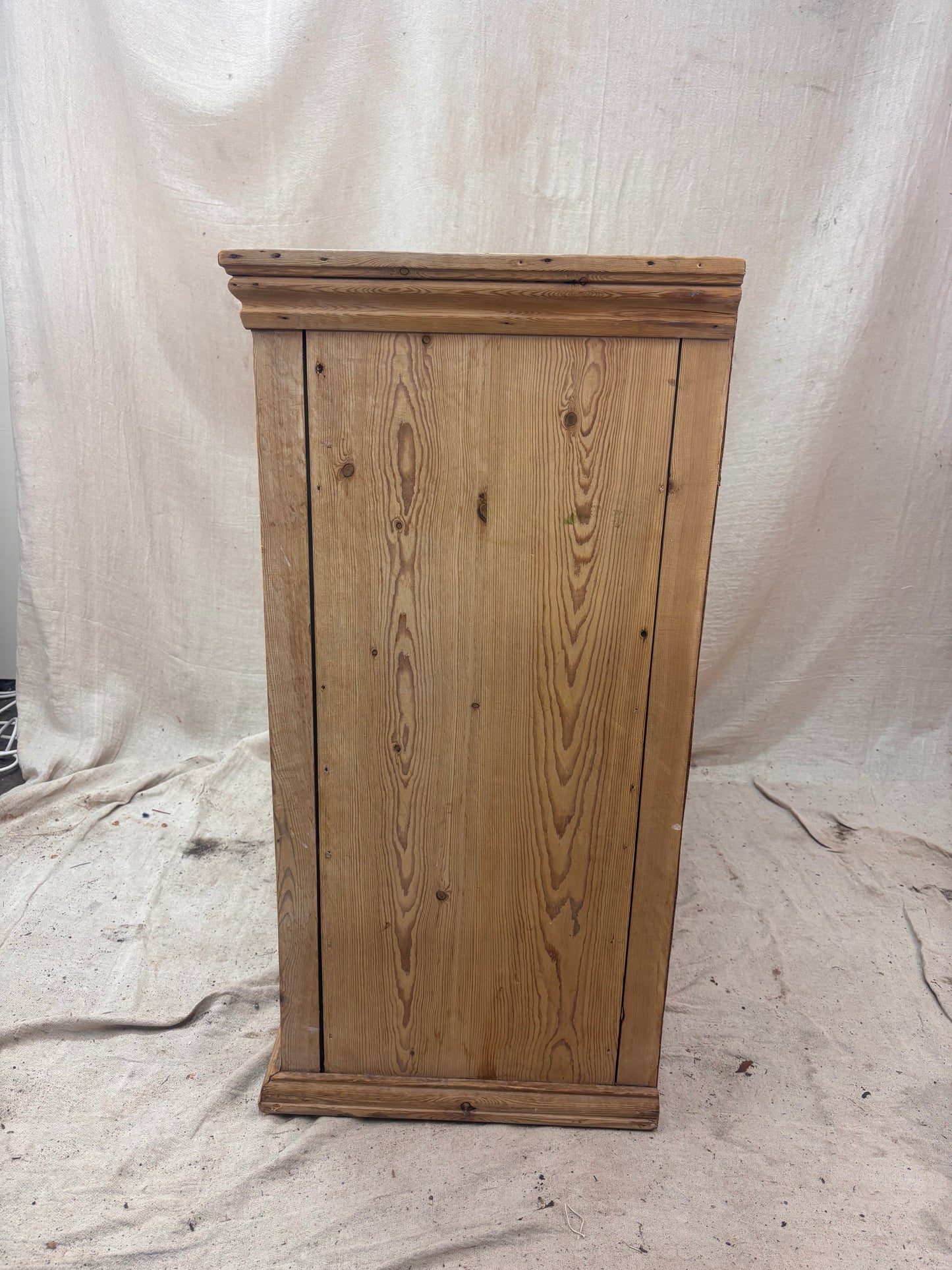 Wooden cabinet on a white fabric background