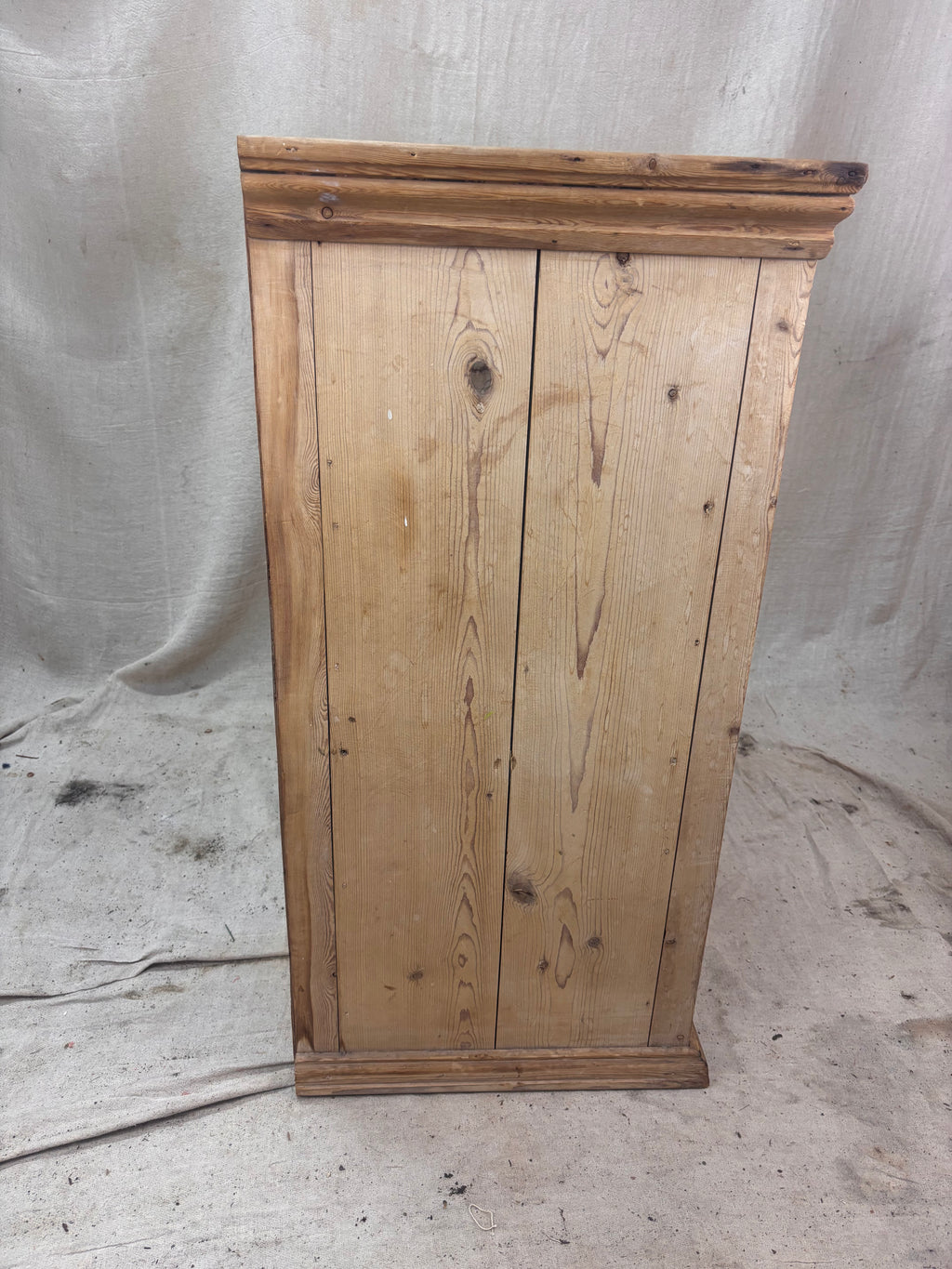 Wooden cabinet with a rustic finish on a plain background
