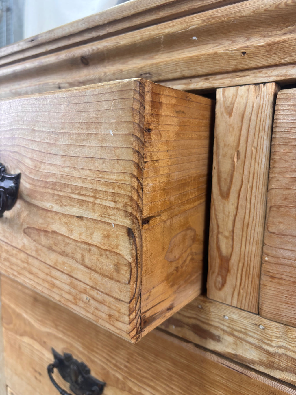Close-up of a wooden drawer with visible grain and texture