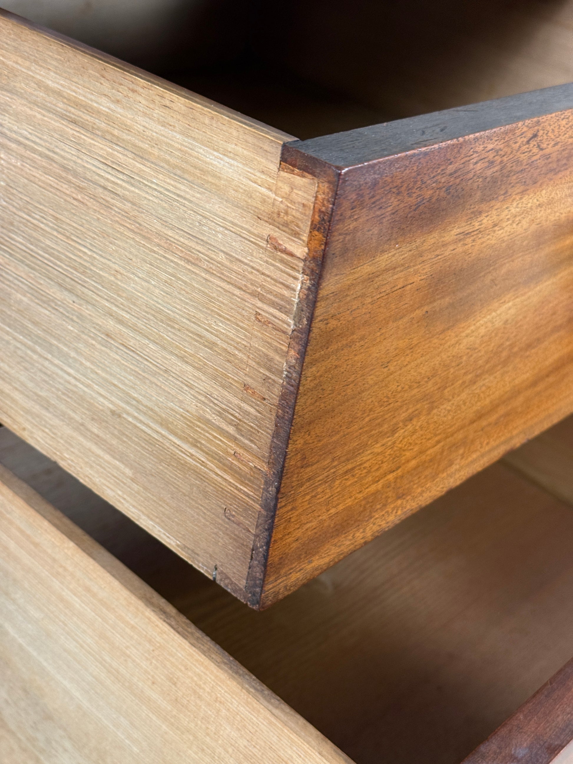 Close-up of wooden furniture corner with a focus on the grain and texture.