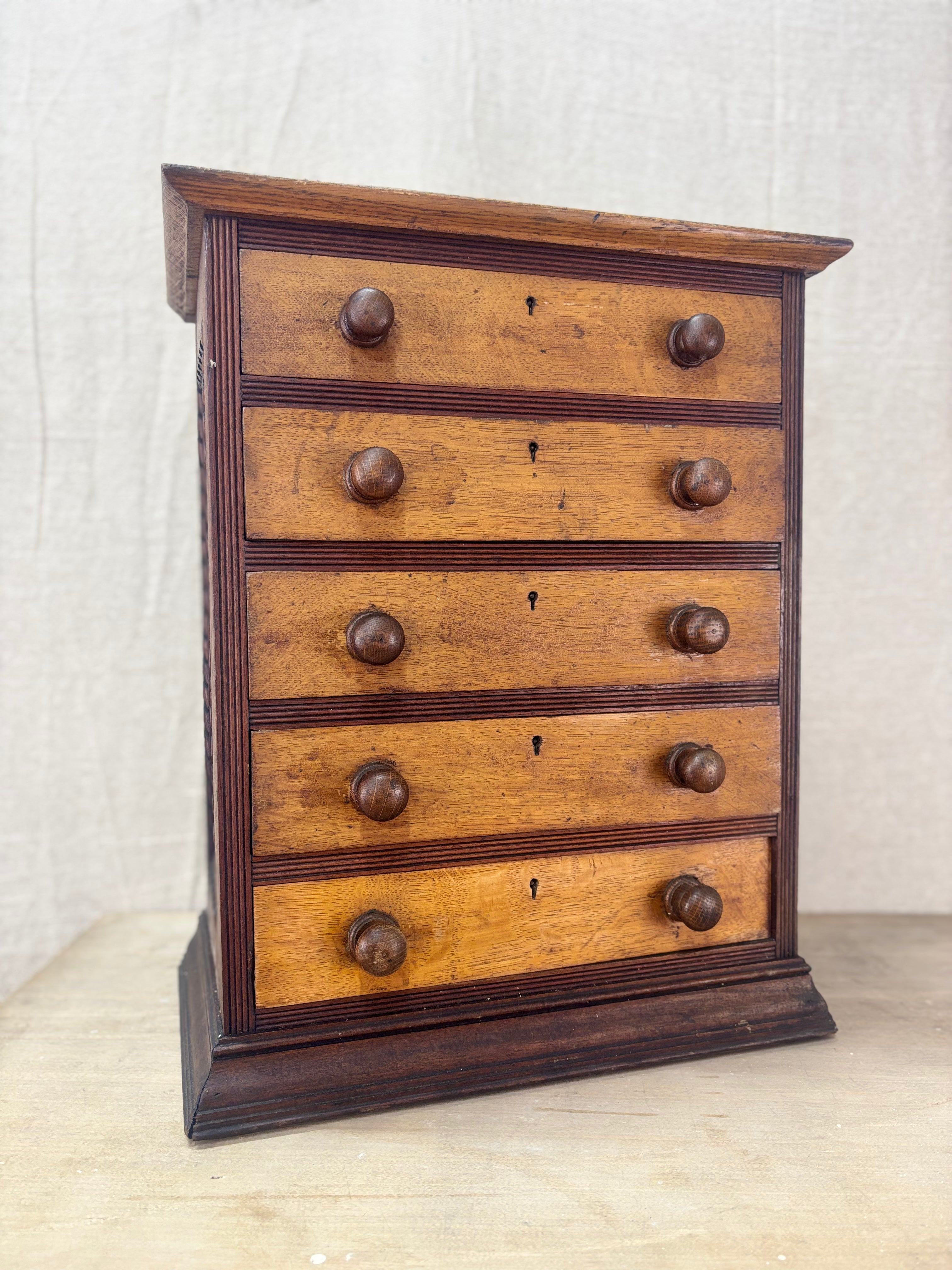 Wooden chest with multiple drawers on a light background