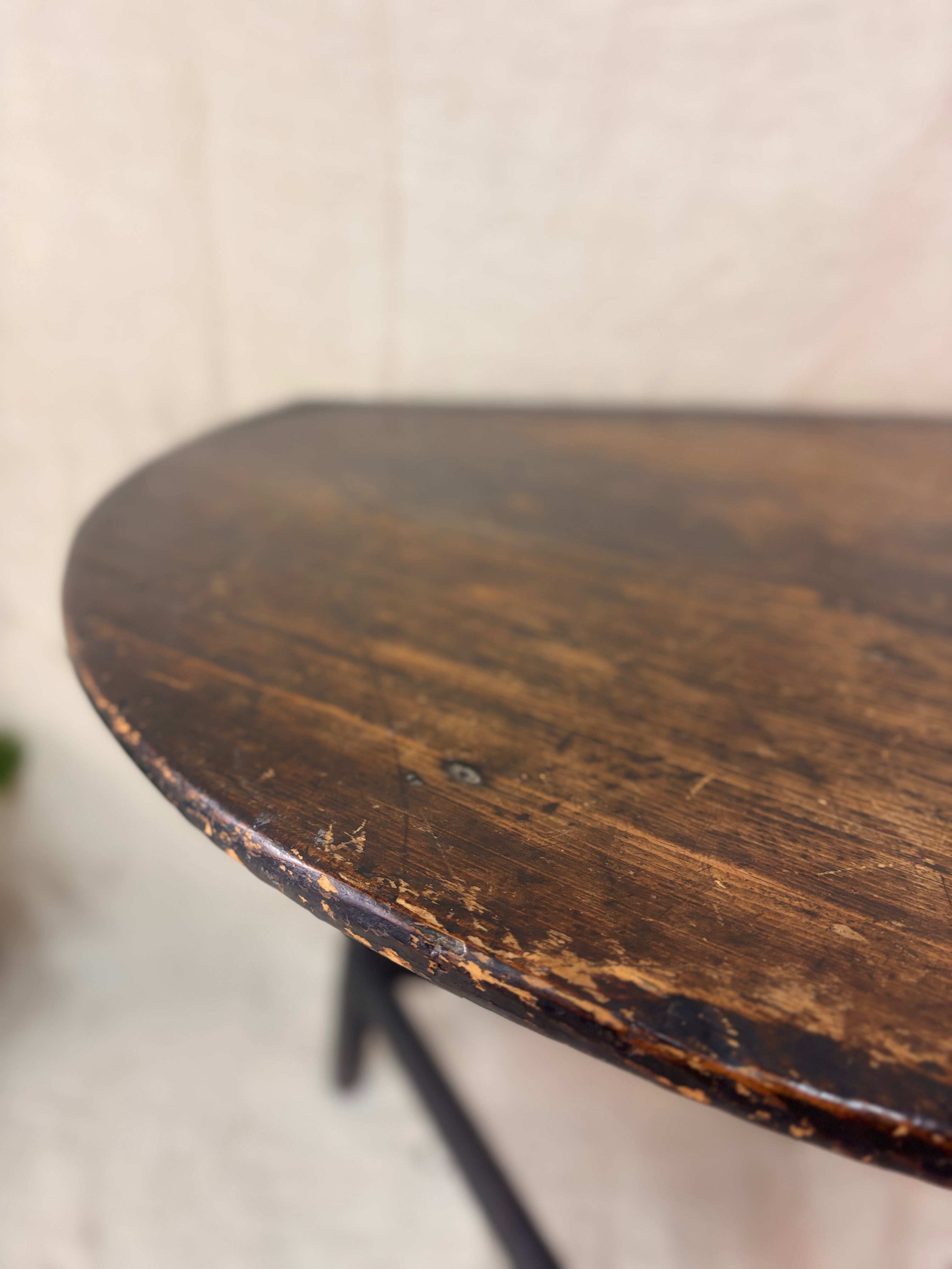 Close-up of a wooden table with a worn surface on a blurred background