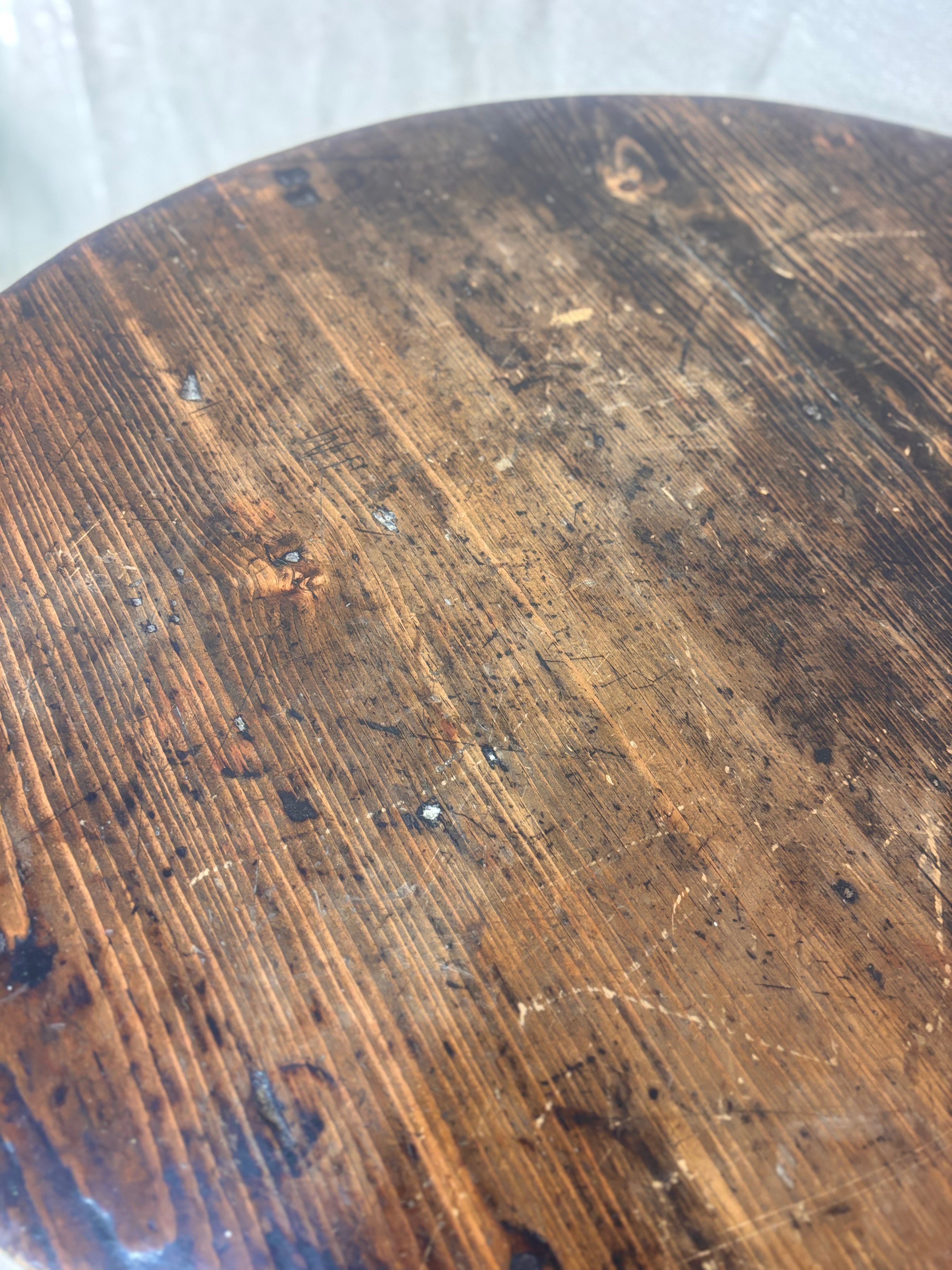 Round wooden surface with visible grain and wear