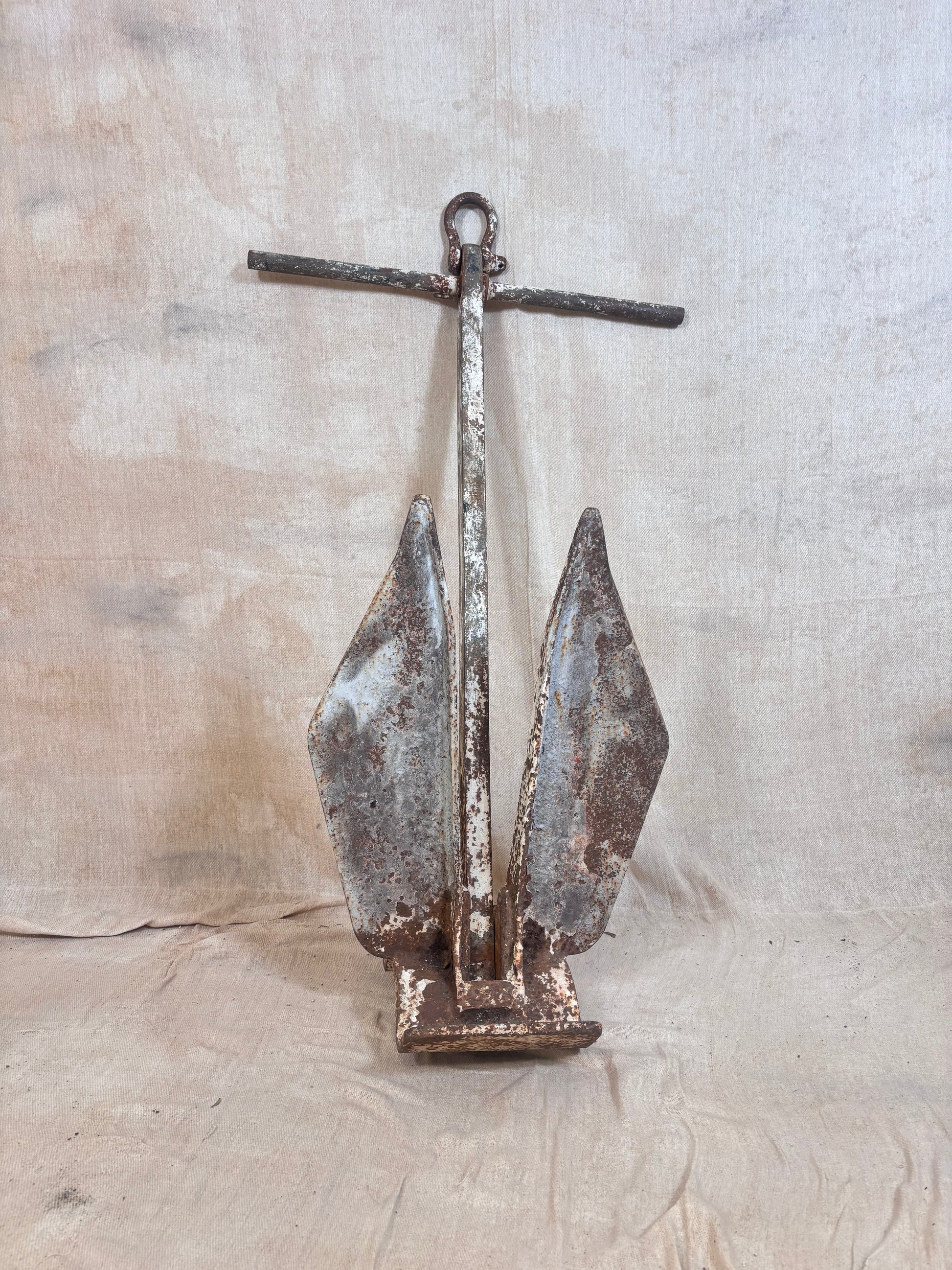 Vintage Danforth style ship anchor with folding flukes, original worn paint and surface rust. A nautical display piece for coastal interiors or garden settings.