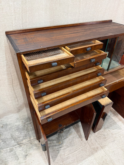 Wooden drawer with glass top on a concrete floor