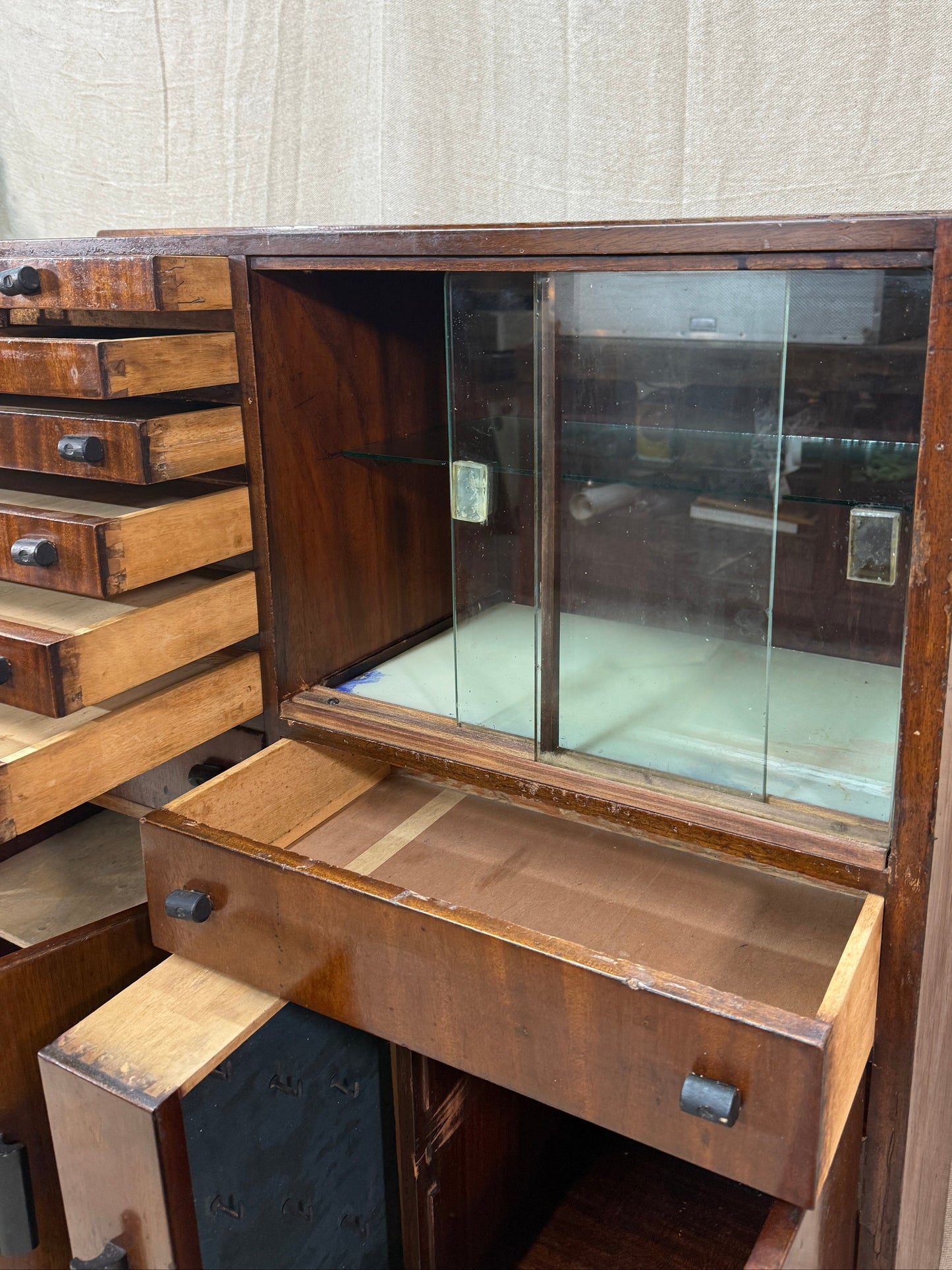 Wooden dentist cabinet with glass lid on a textured surface