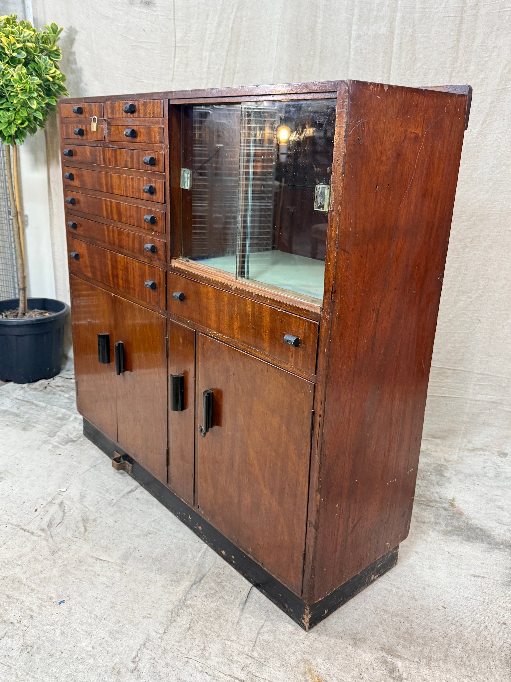 Wooden cabinet with glass door on a concrete floor