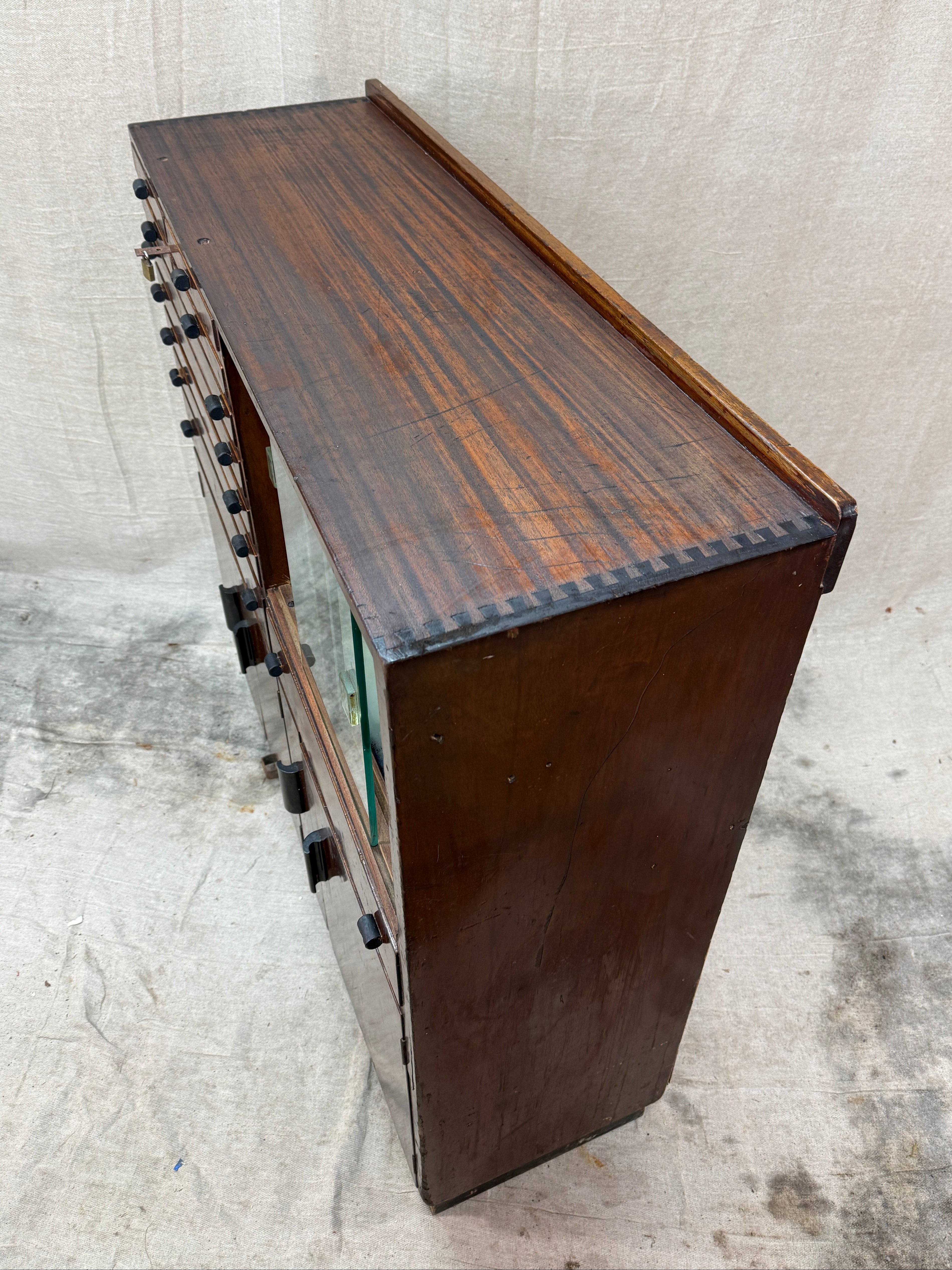 Wooden cabinet with a textured surface on a light gray background