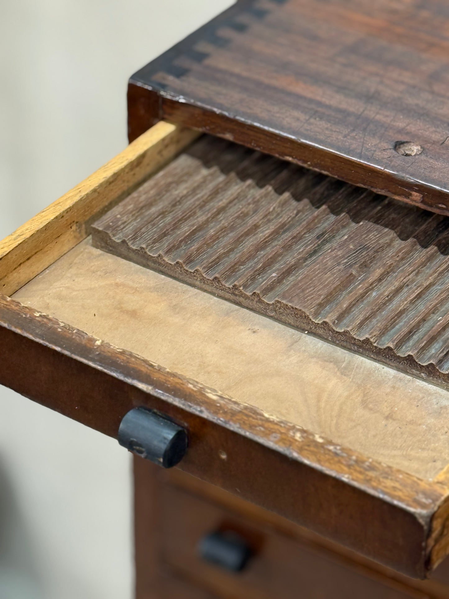 Close-up of a wooden drawer with a textured interior
