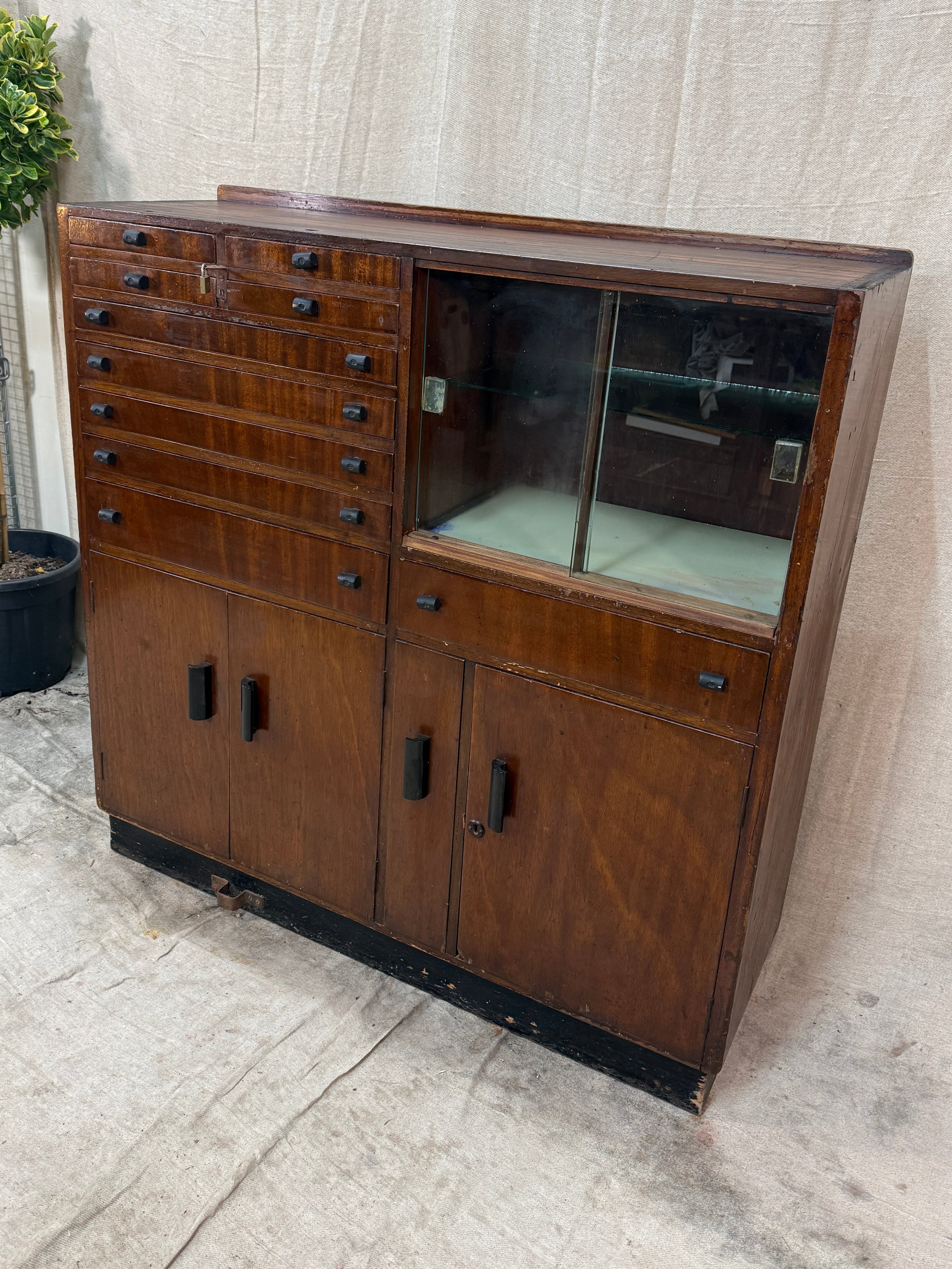 Wooden cabinet with glass door on a concrete floor