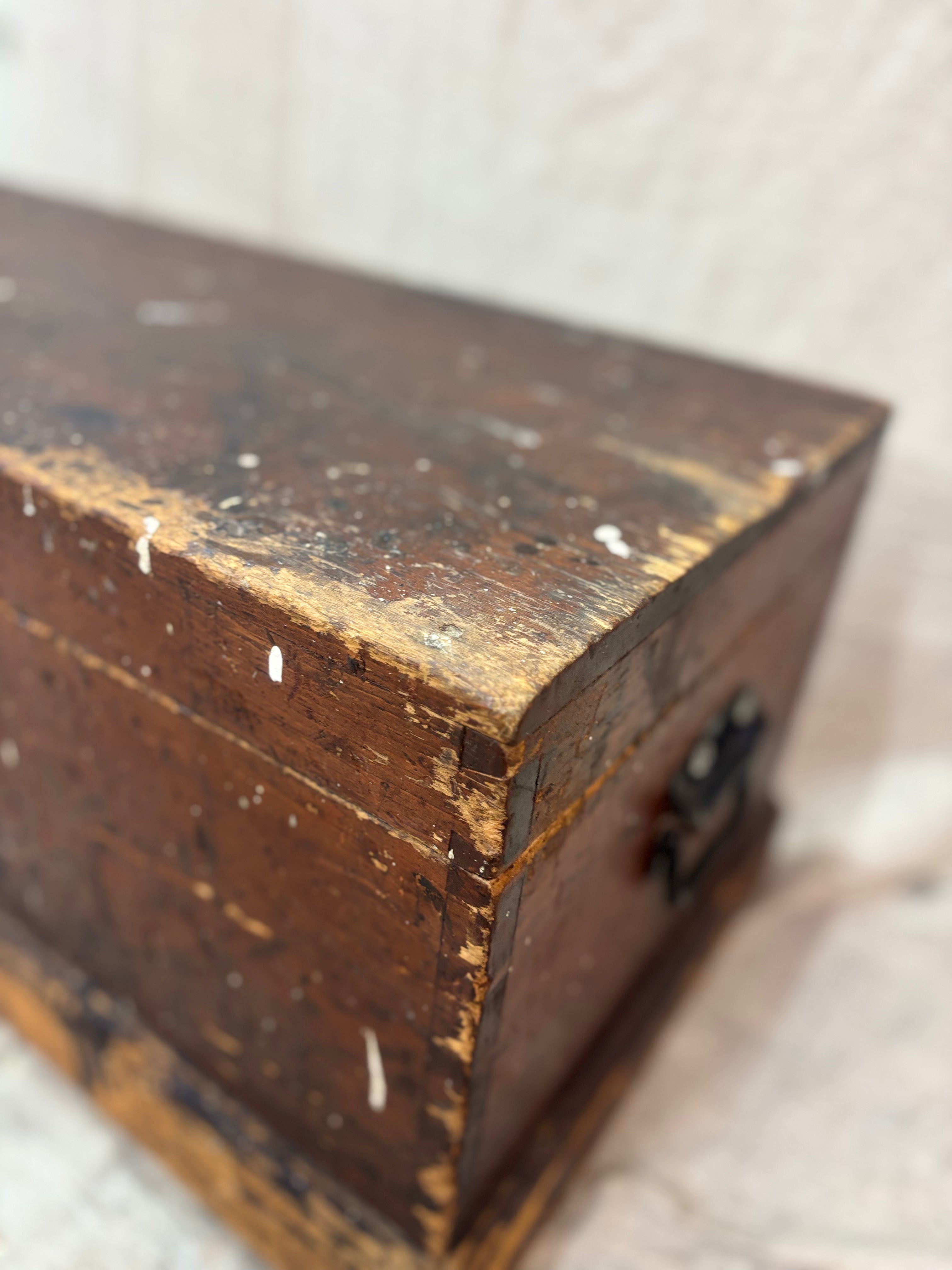 Close-up of an old wooden box with a worn surface on a light background