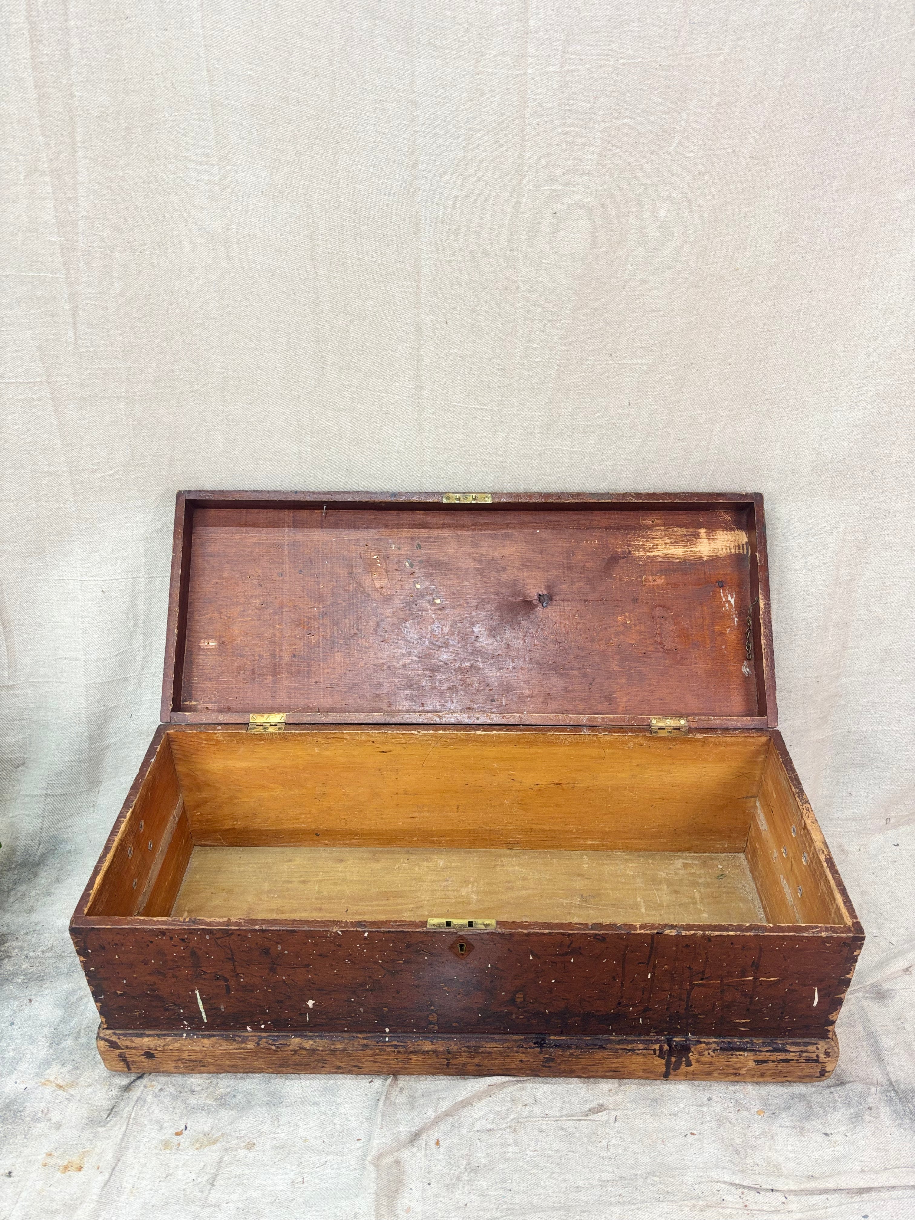 Wooden trunk with a hinged lid on a textured surface