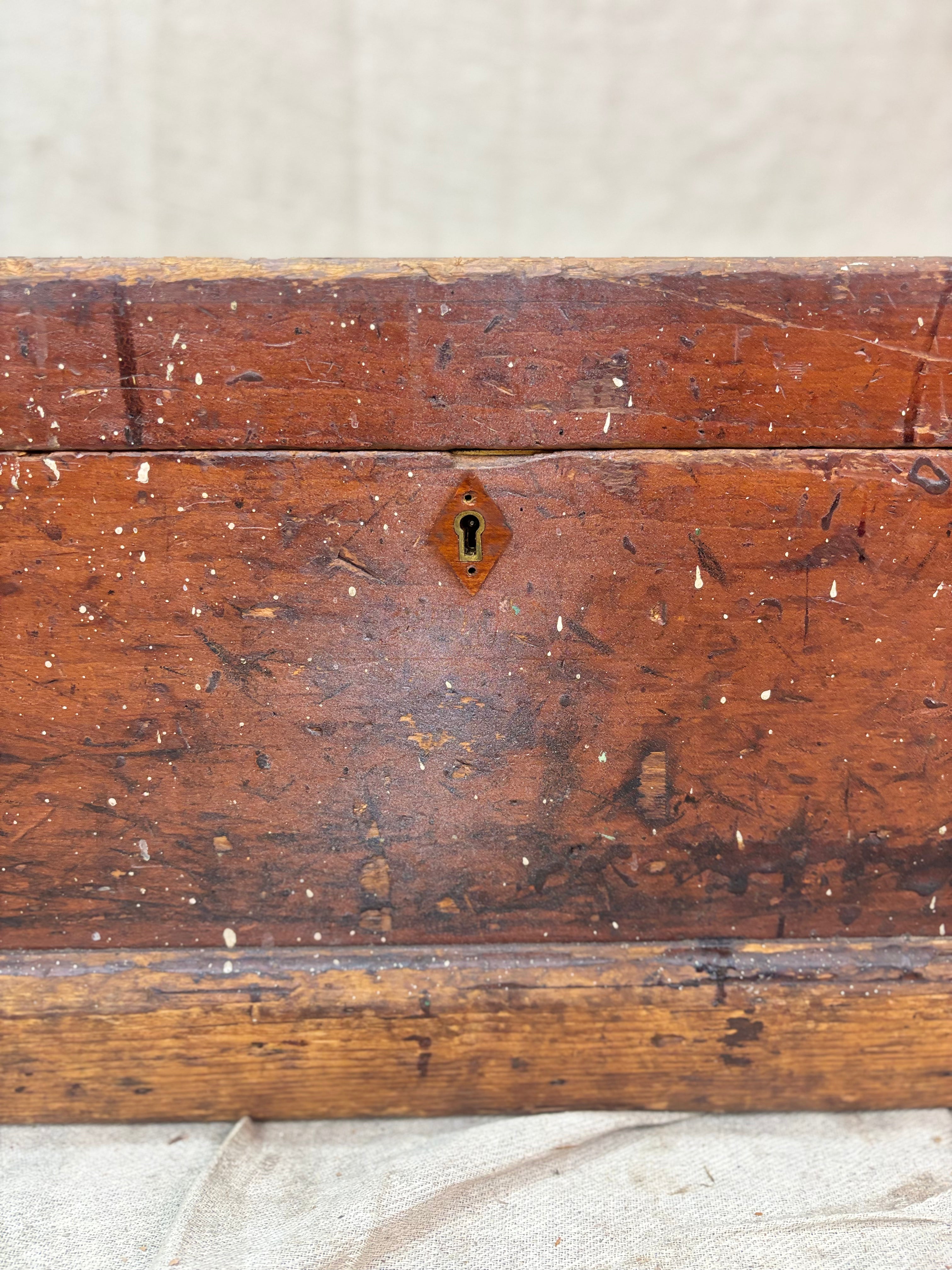 Close-up of a wooden chest with a keyhole on a textured surface
