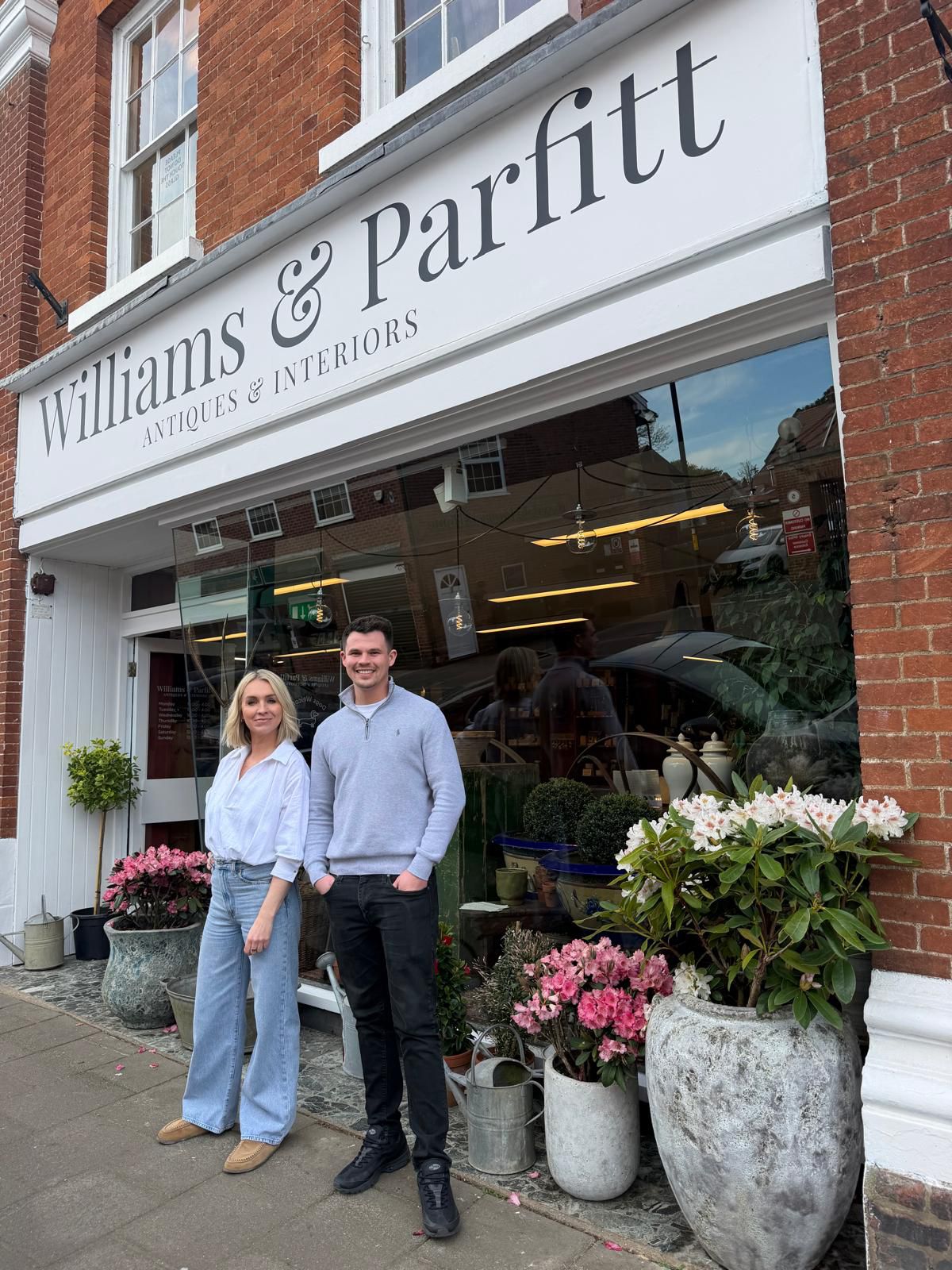Donna Williams and Ryan Parfitt standing outside a store named 'Williams & Parfitt' with plants and flowers around.