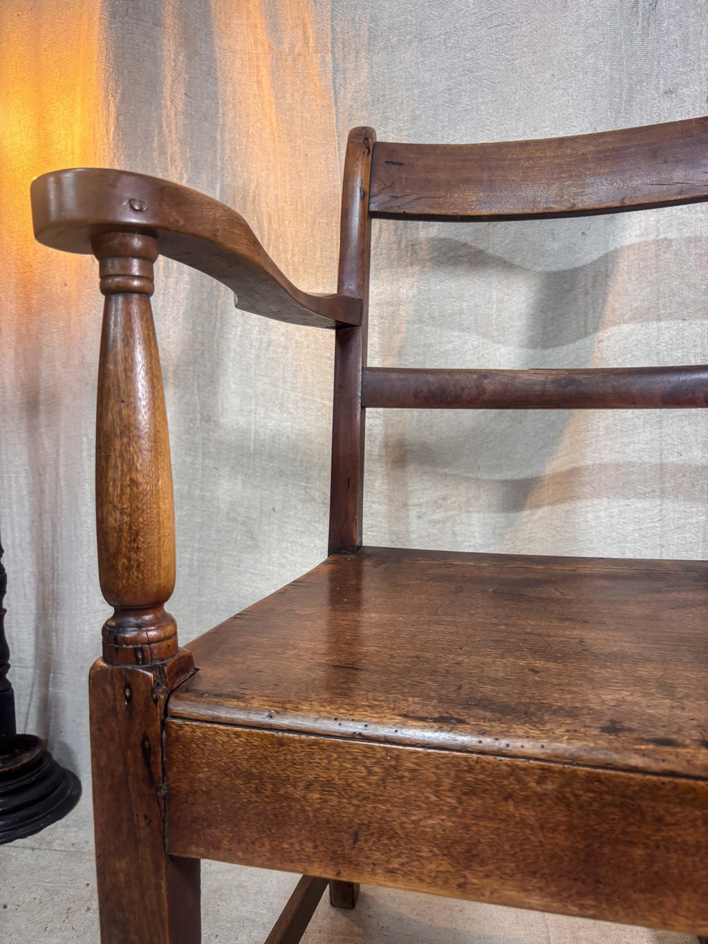 Wooden chair with a textured wall in the background