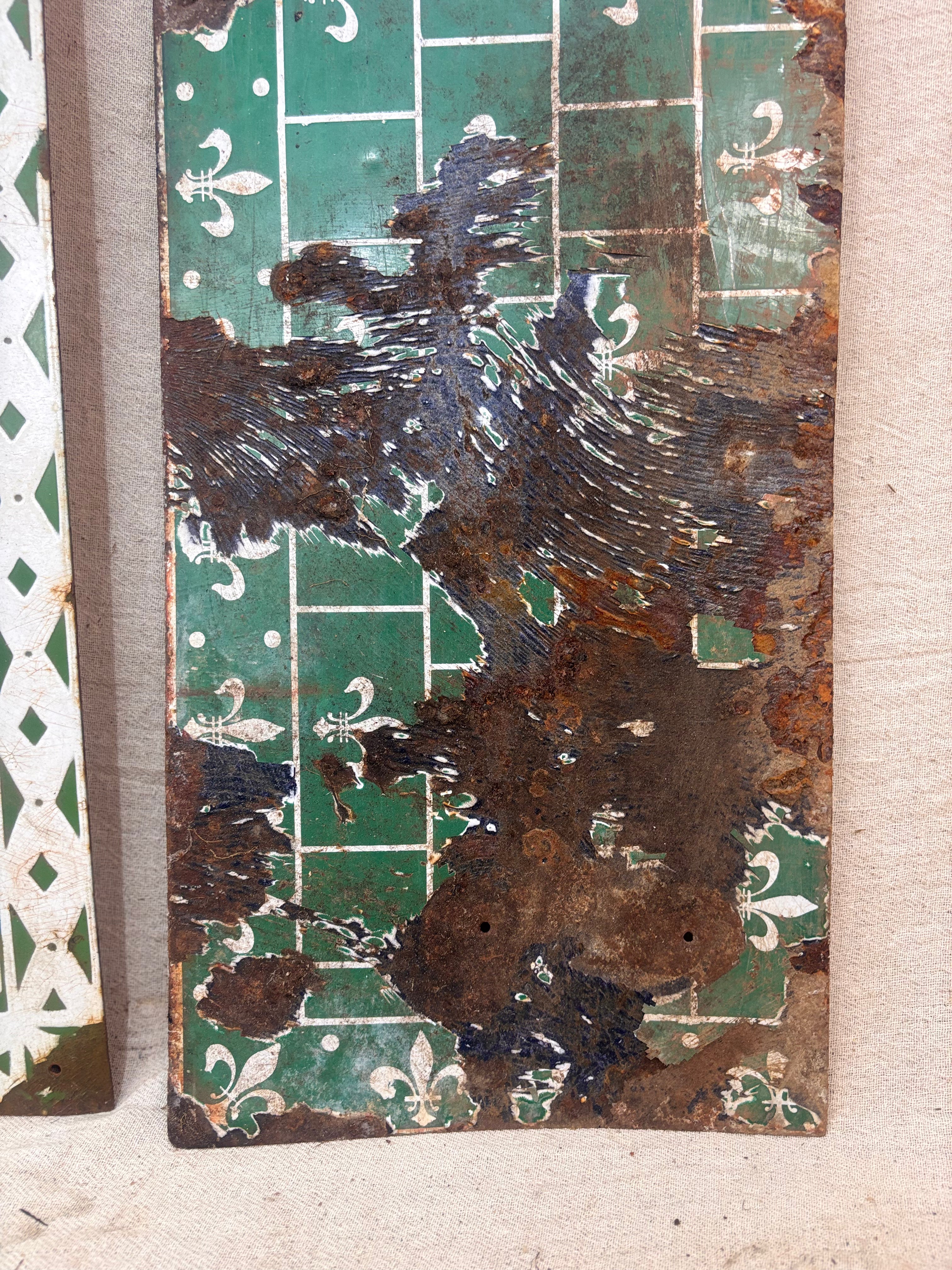 Rust-covered metal panel with decorative patterns on a textured surface