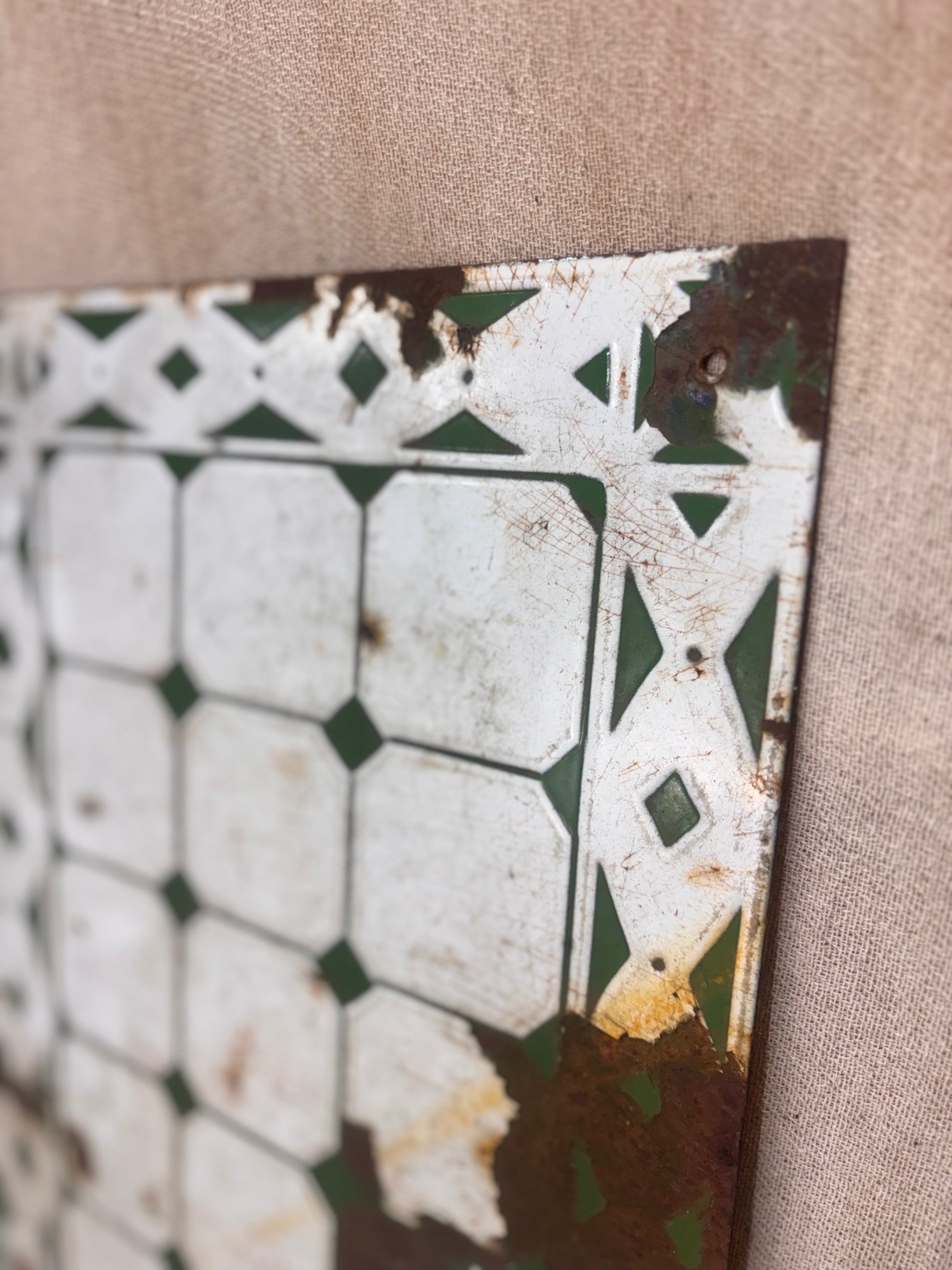 Decorative metal tile with geometric pattern on a beige fabric background