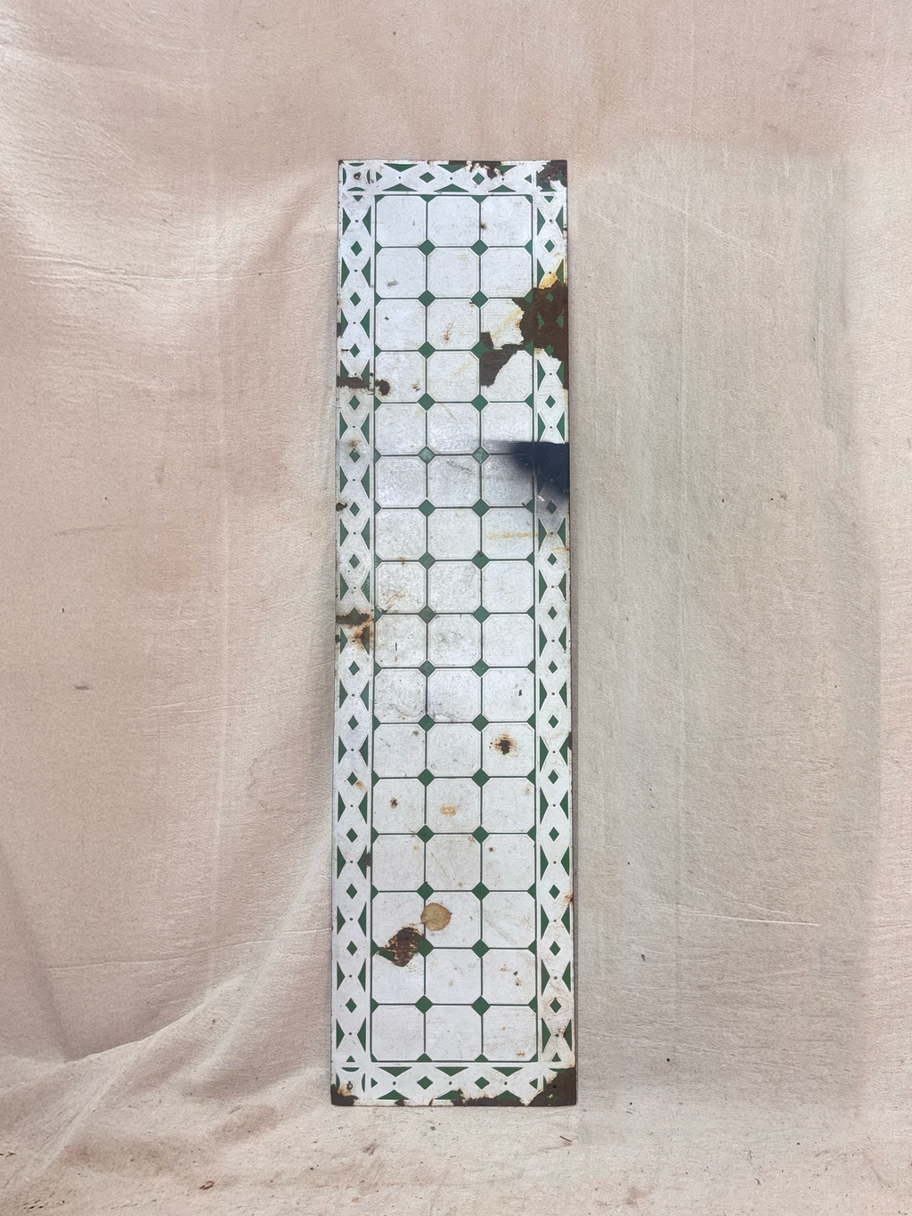 Decorative rectangular panel with a geometric pattern on a beige fabric background