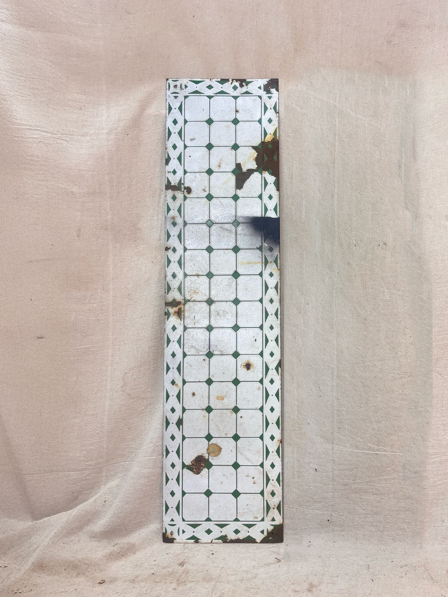 Decorative rectangular panel with a geometric pattern on a beige fabric background