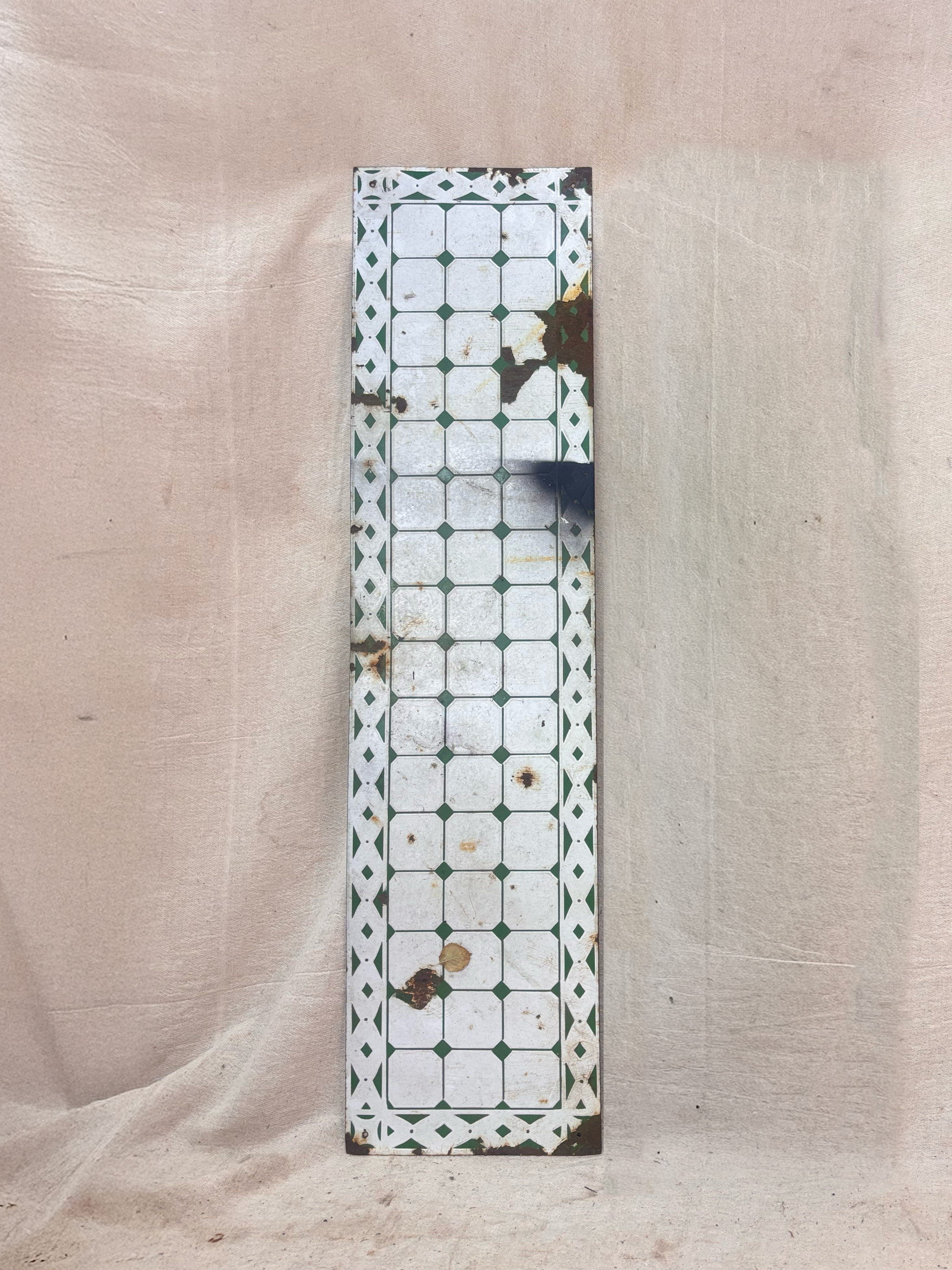 Decorative rectangular panel with a geometric pattern on a beige fabric background