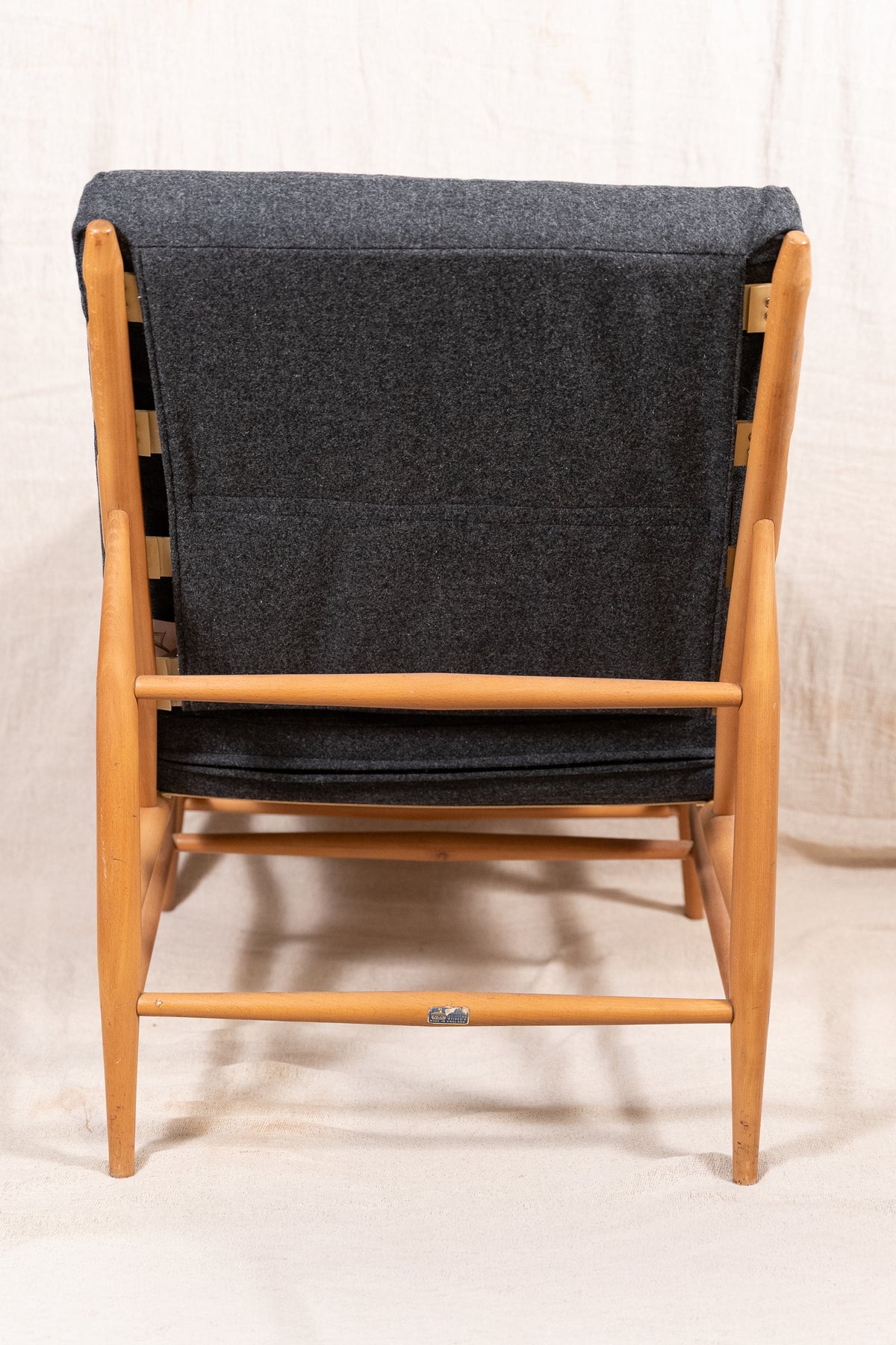 Mid-century modern Ercol Floating lounge chair, model 427, with a solid elm and beech frame and dark grey upholstered cushions. 
