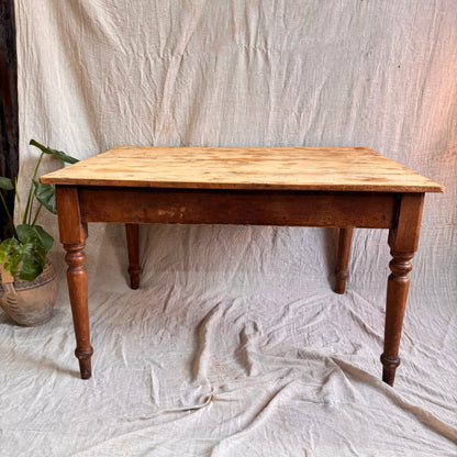 Wooden table on a textured white fabric background