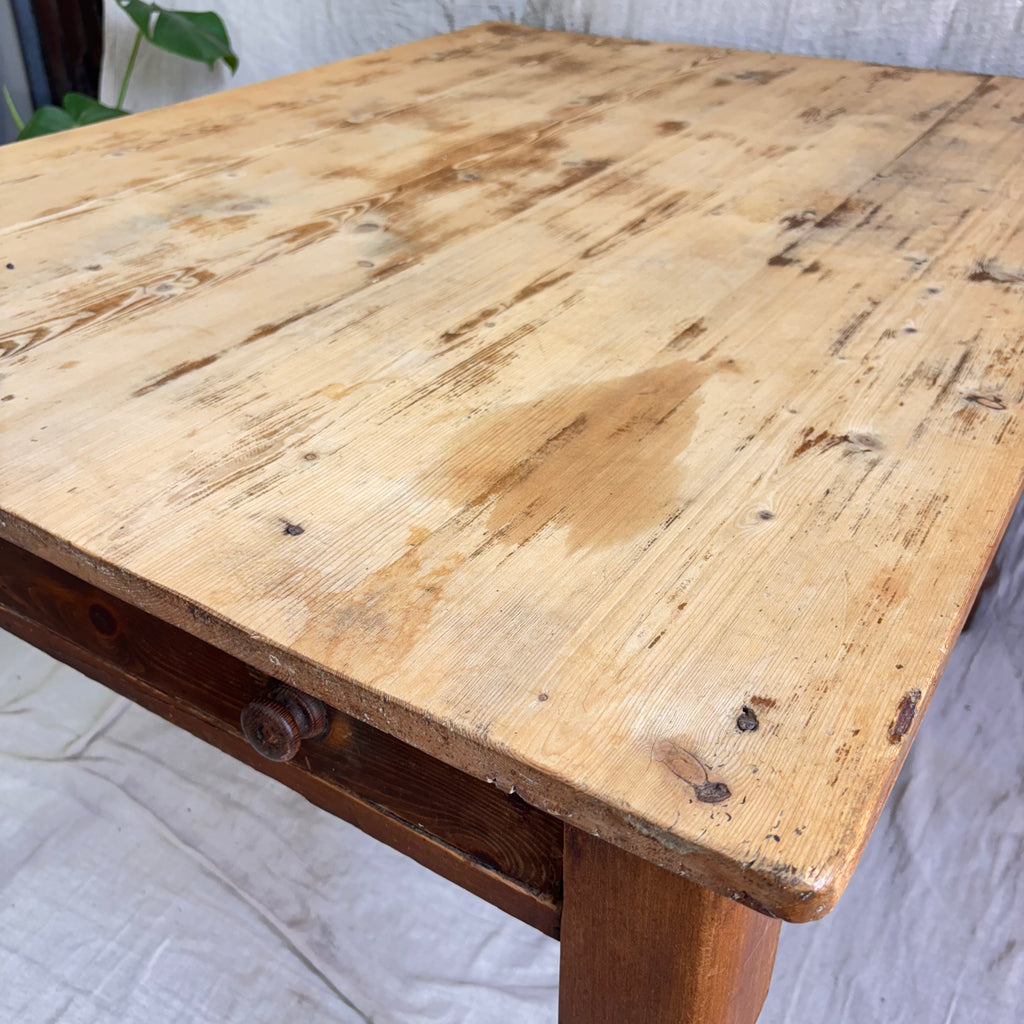 Wooden table with a rustic appearance on a white fabric background