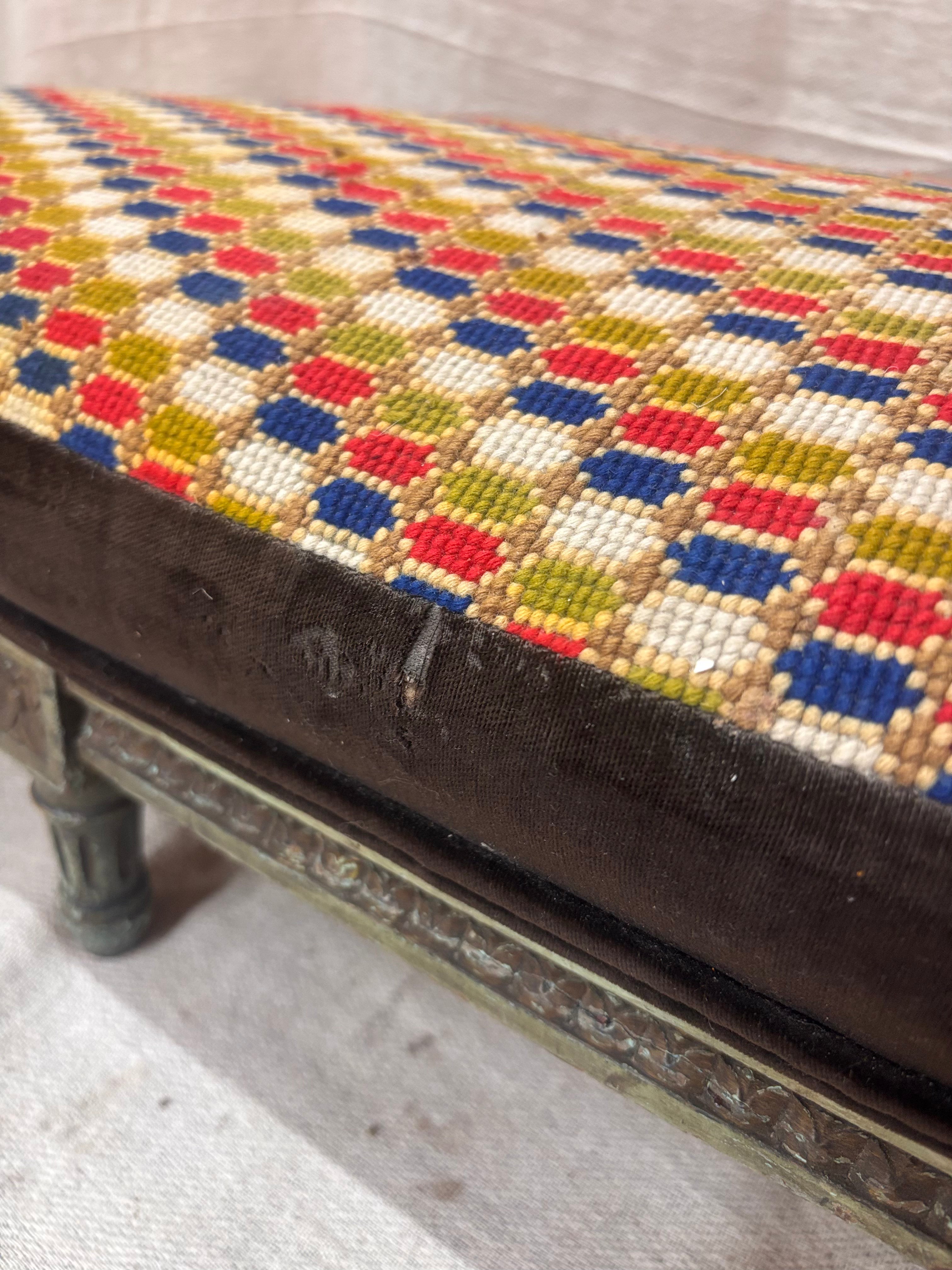Decorative bench with a multicolored geometric pattern on a textured surface