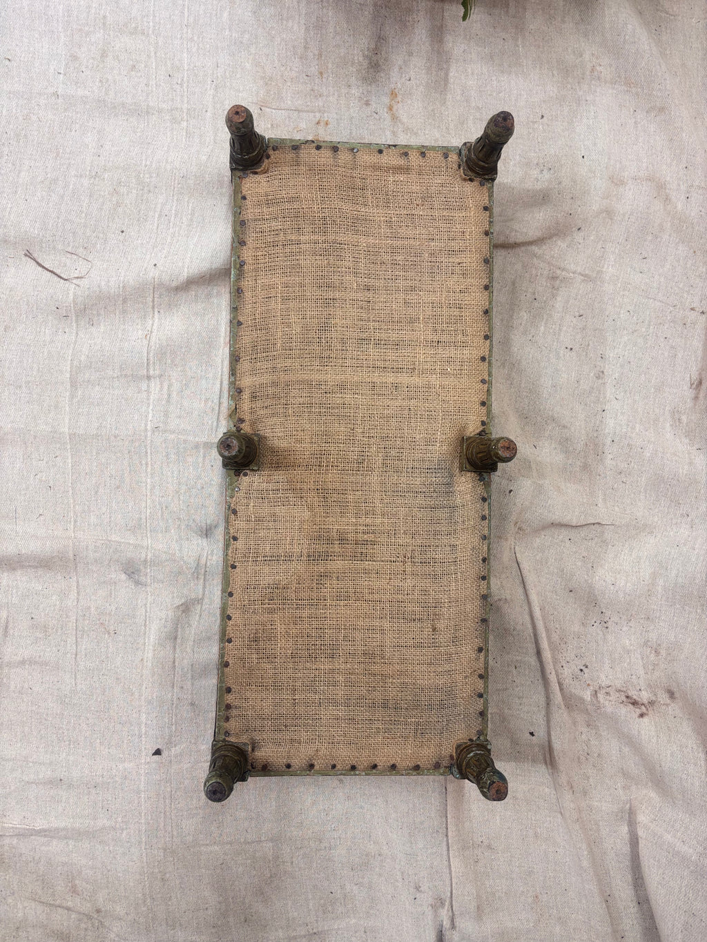 Underside of footstool on a cream background