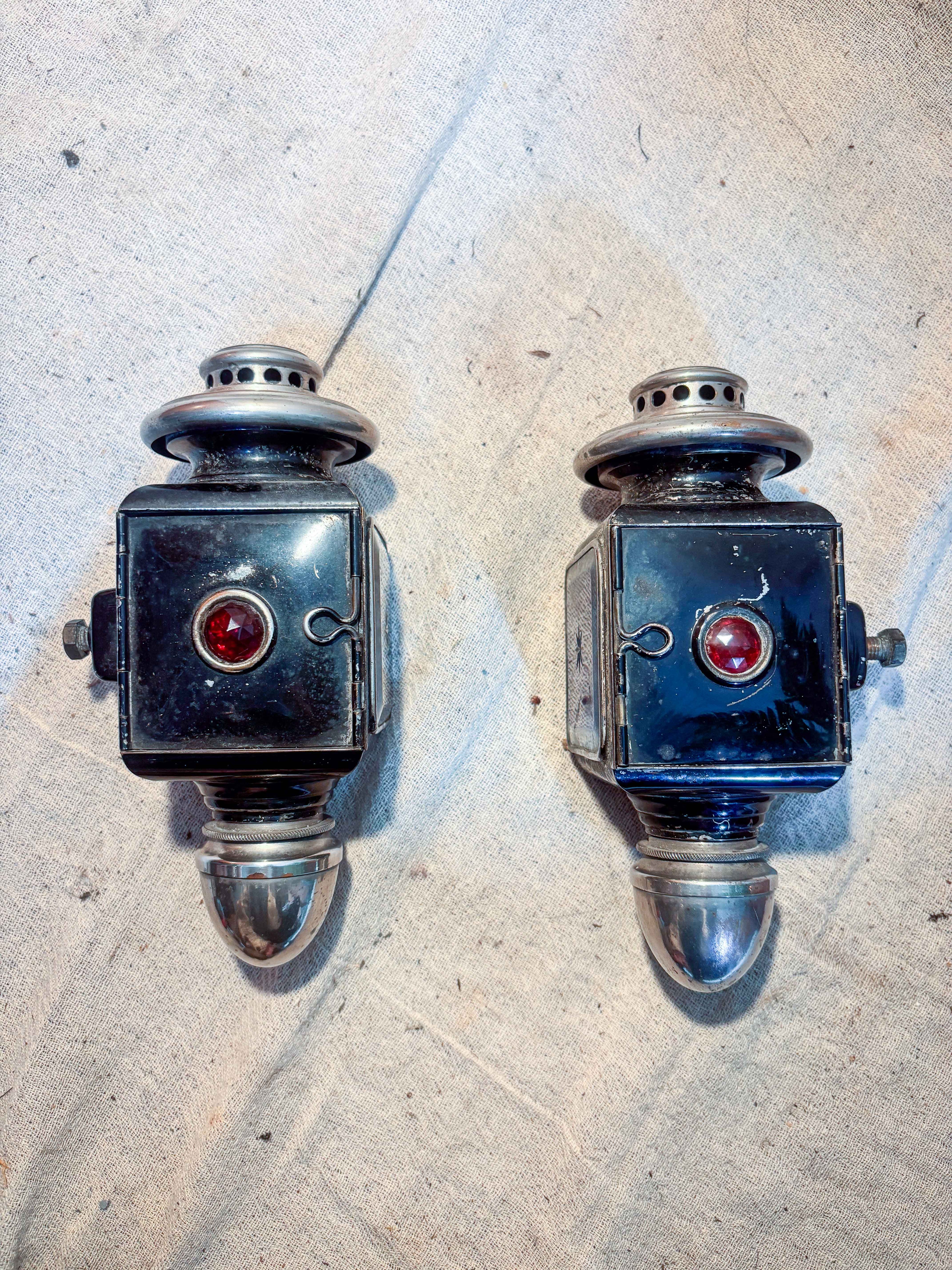 Two carriage lamps on a textured surface