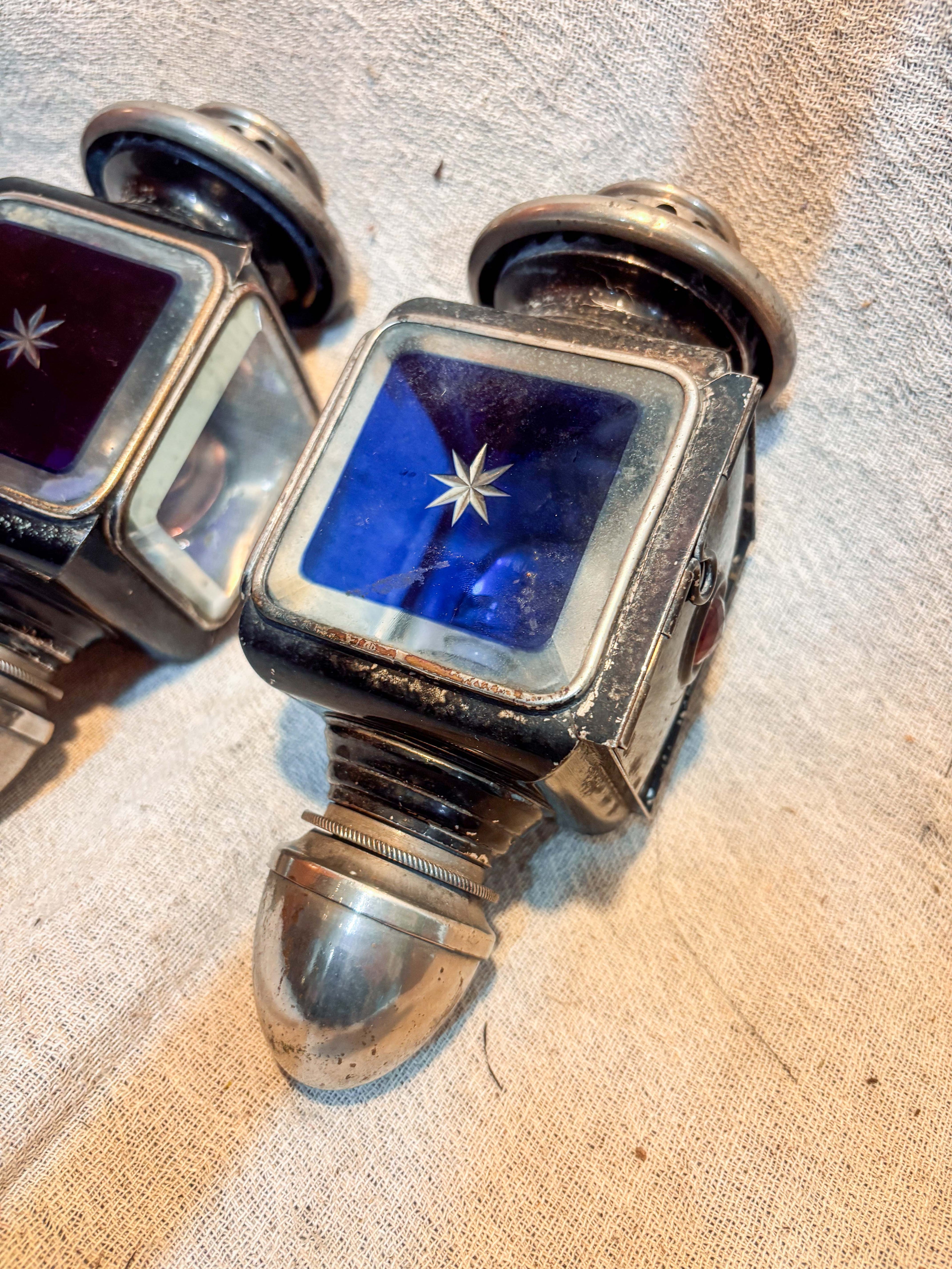 Antique Carriage Lamps with blue glass on a textured background 