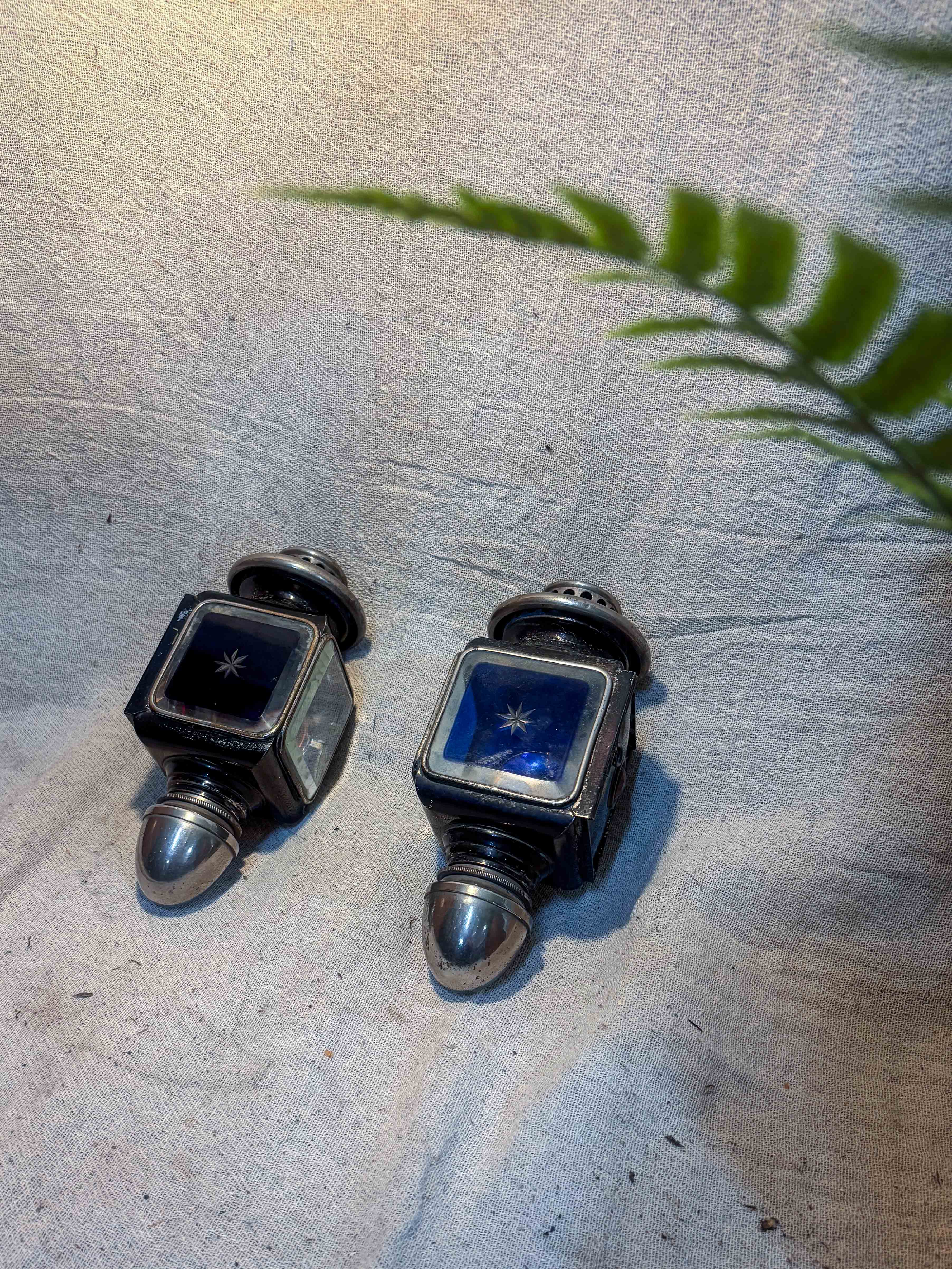 Antique French Carriage Lamps on a textured beige cloth