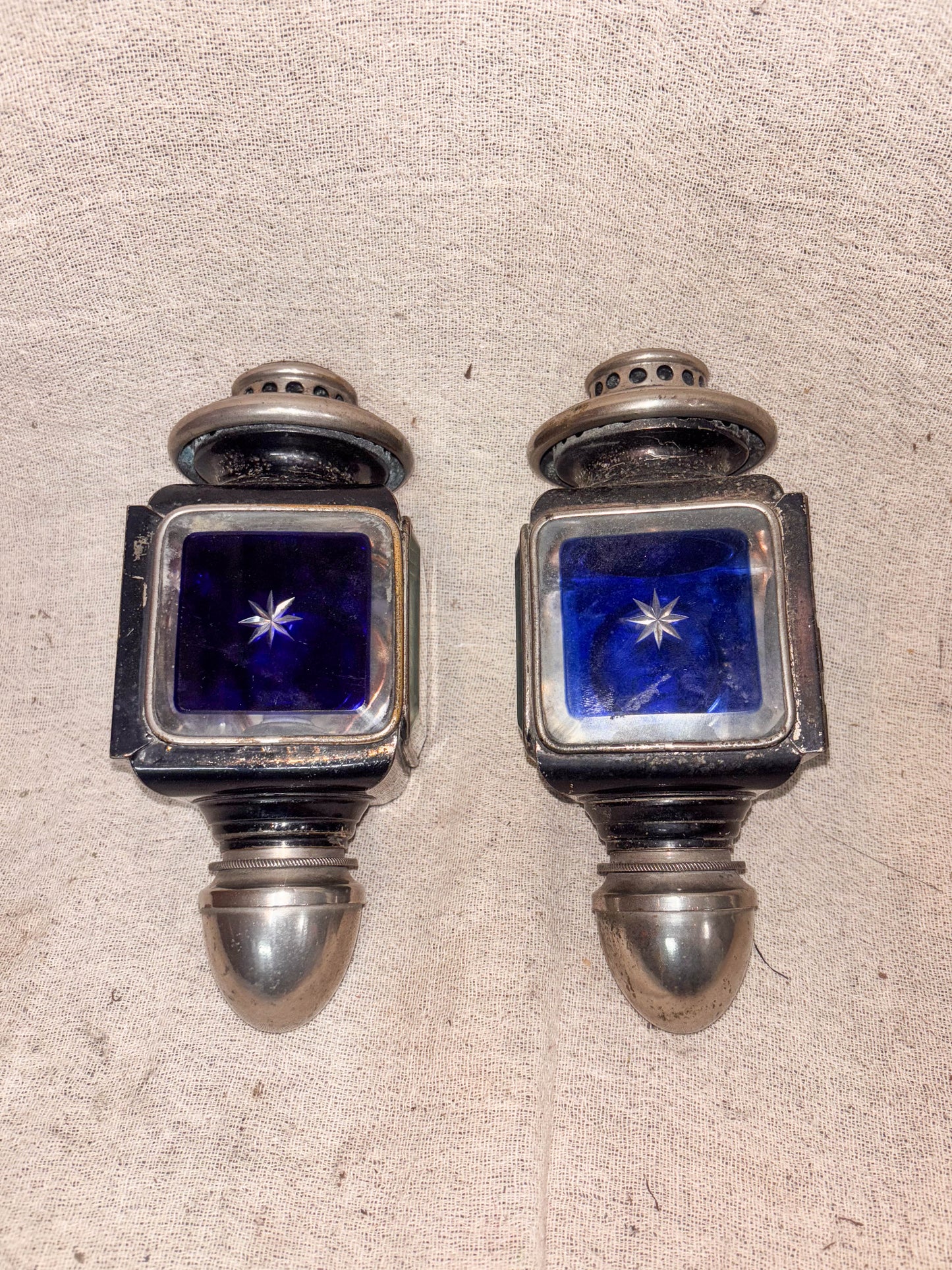 Blue Glass Carriage Lamps on a cloth background