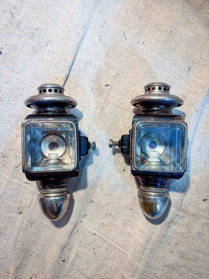 two small carriage lamps on cloth background
