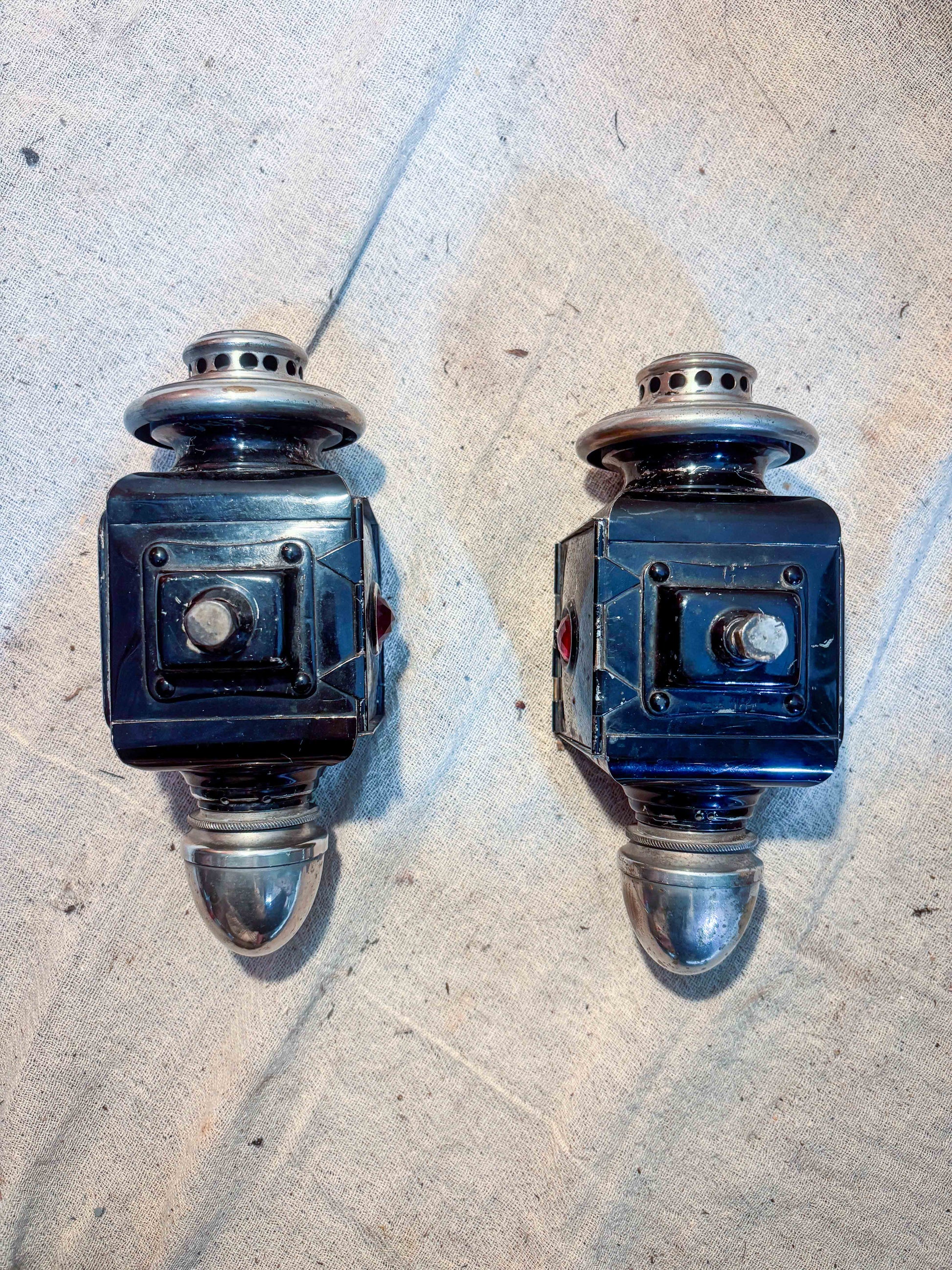 Pair of carriage lamps on a cloth background