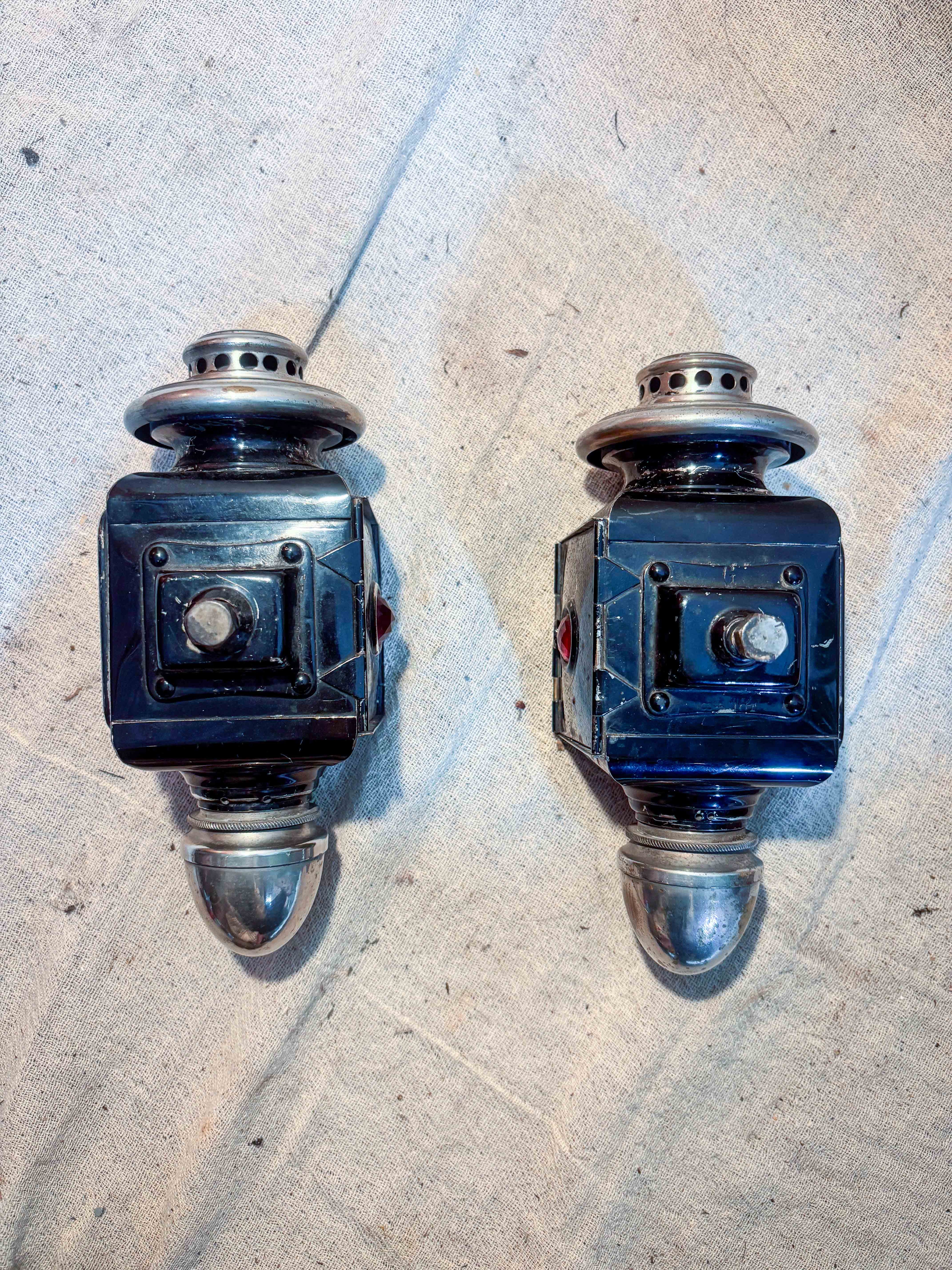 Pair of carriage lamps on a cloth background