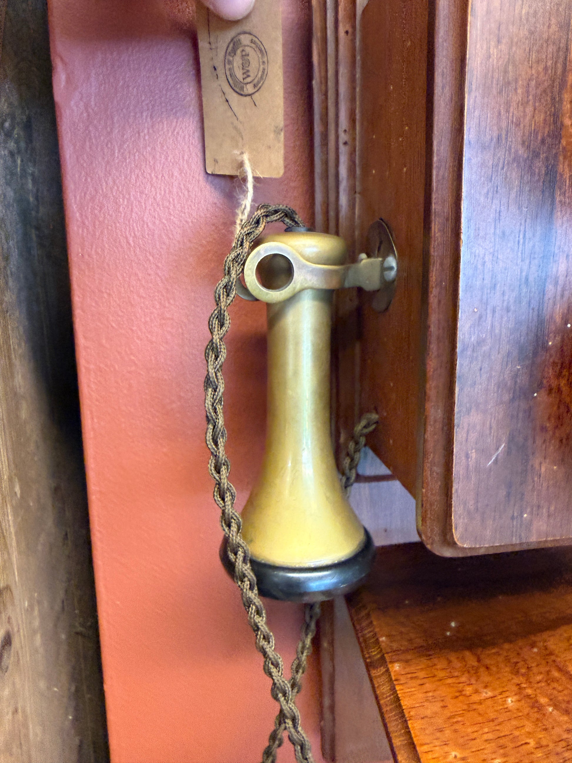 Brass handle on a wooden box with a chain