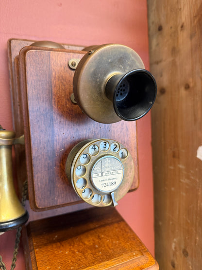 Vintage rotary phone on a wooden surface with a wooden panel background