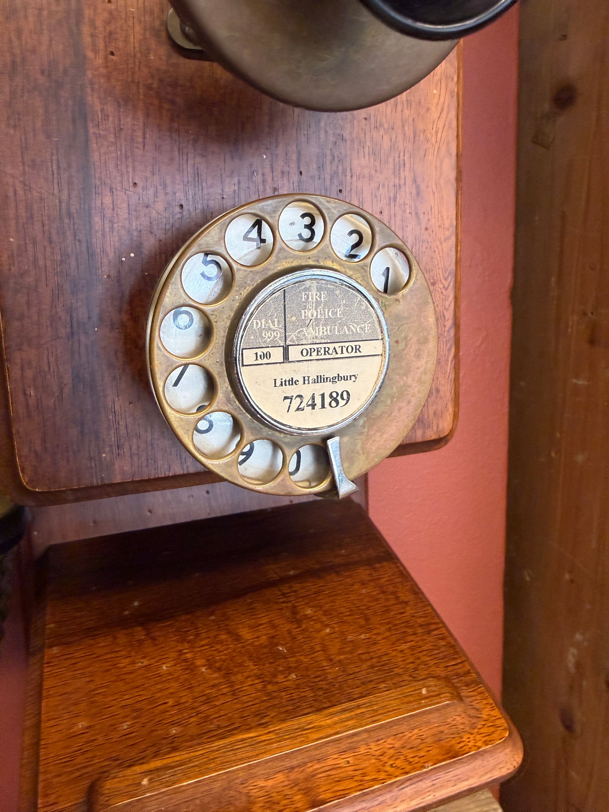 Vintage rotary phone dial on a wooden surface