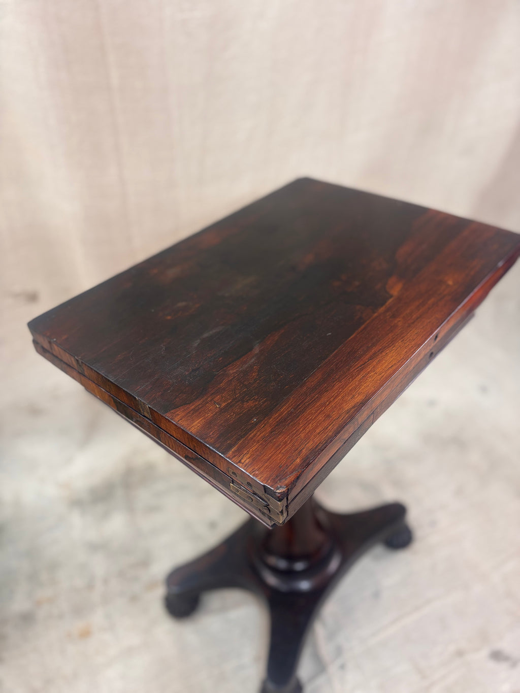 Wooden pedestal table on a neutral background