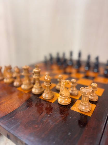 Wooden chess pieces on a chessboard with a blurred background