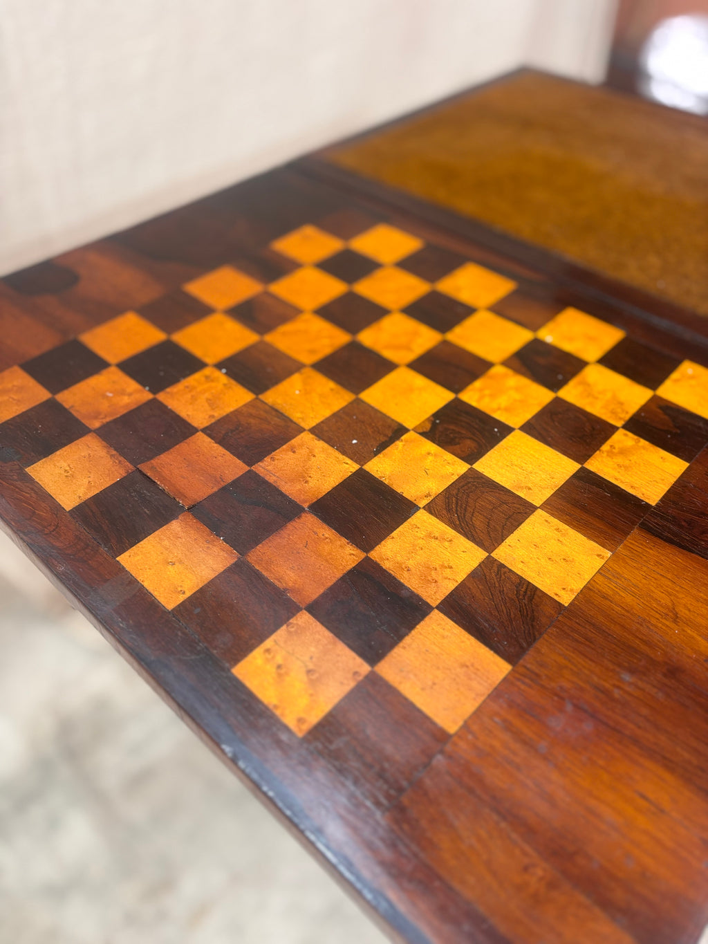 Antique rosewood fold-over games table with inlaid chessboard, baize card surface, turned pedestal base, shown open. 