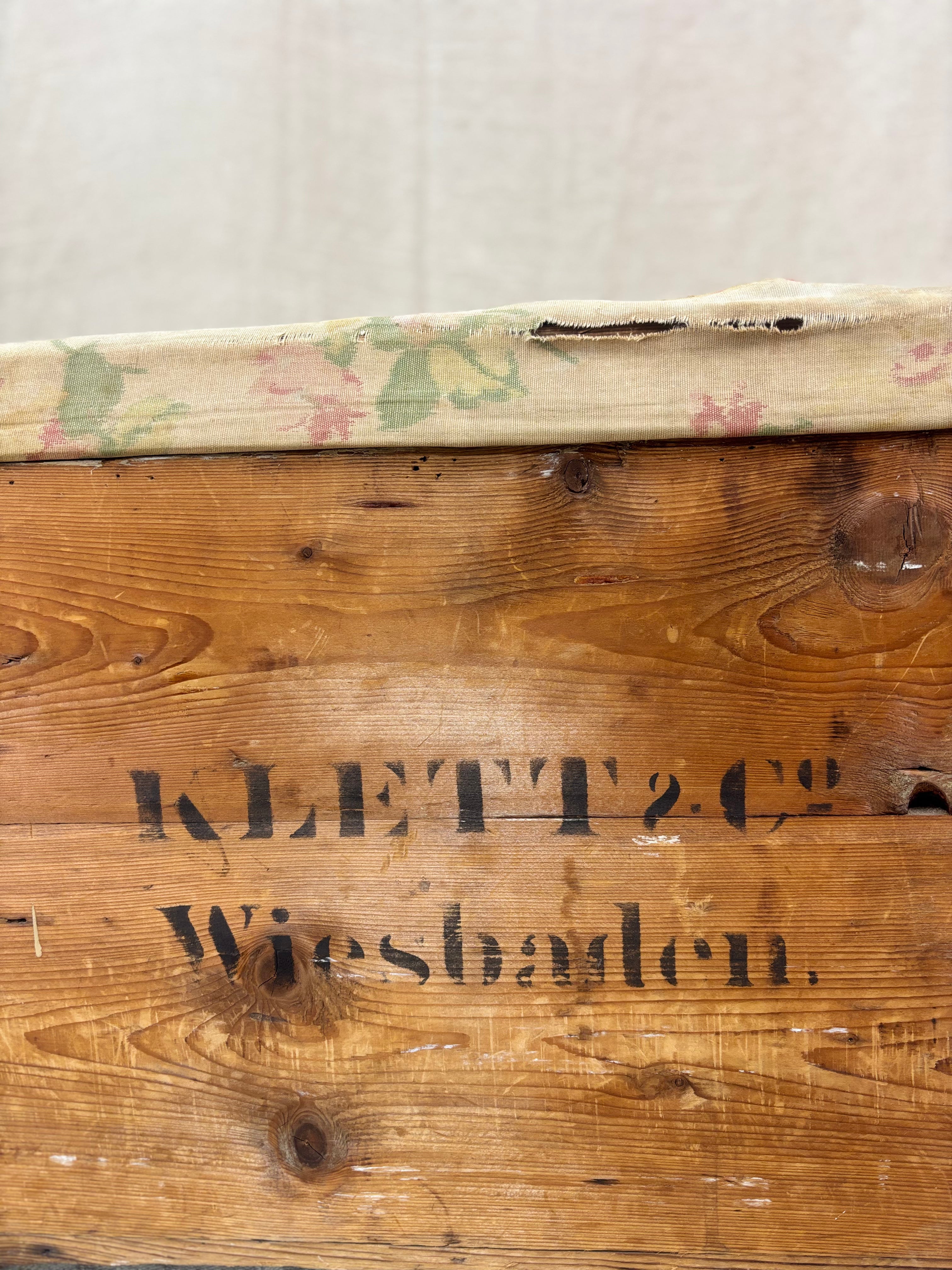 Wooden box with 'Klett & Co. Wiesbaden' branding on a plain background