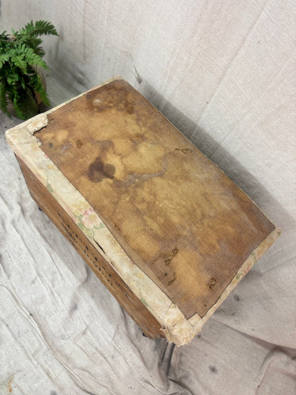 Vintage wooden box with a textured surface on a light fabric background