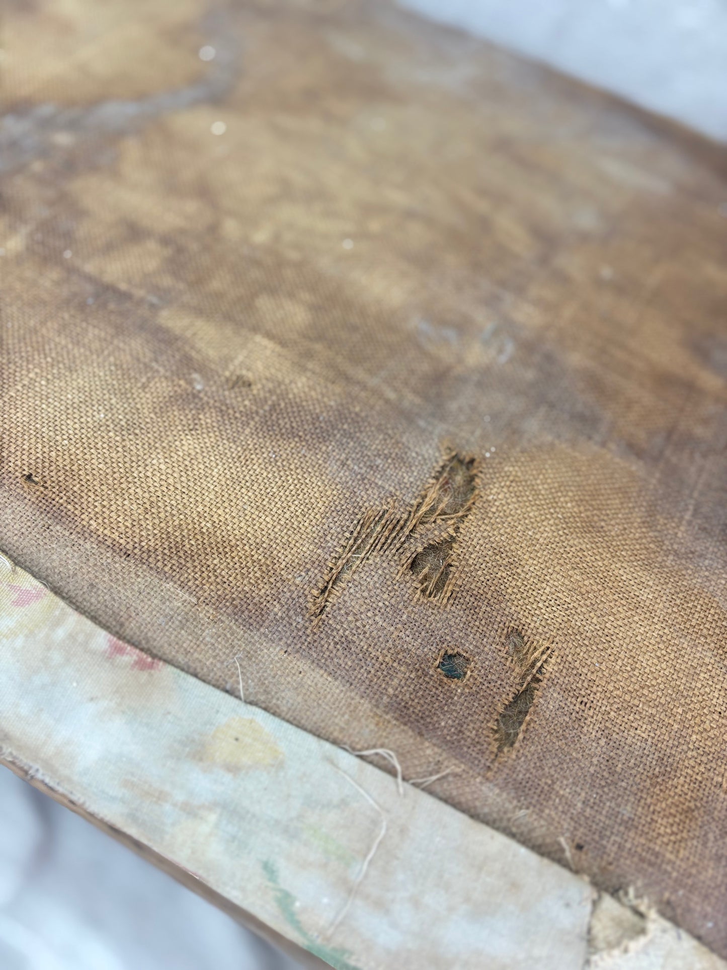 Close-up of an old, worn trunk with visible damage and discoloration.